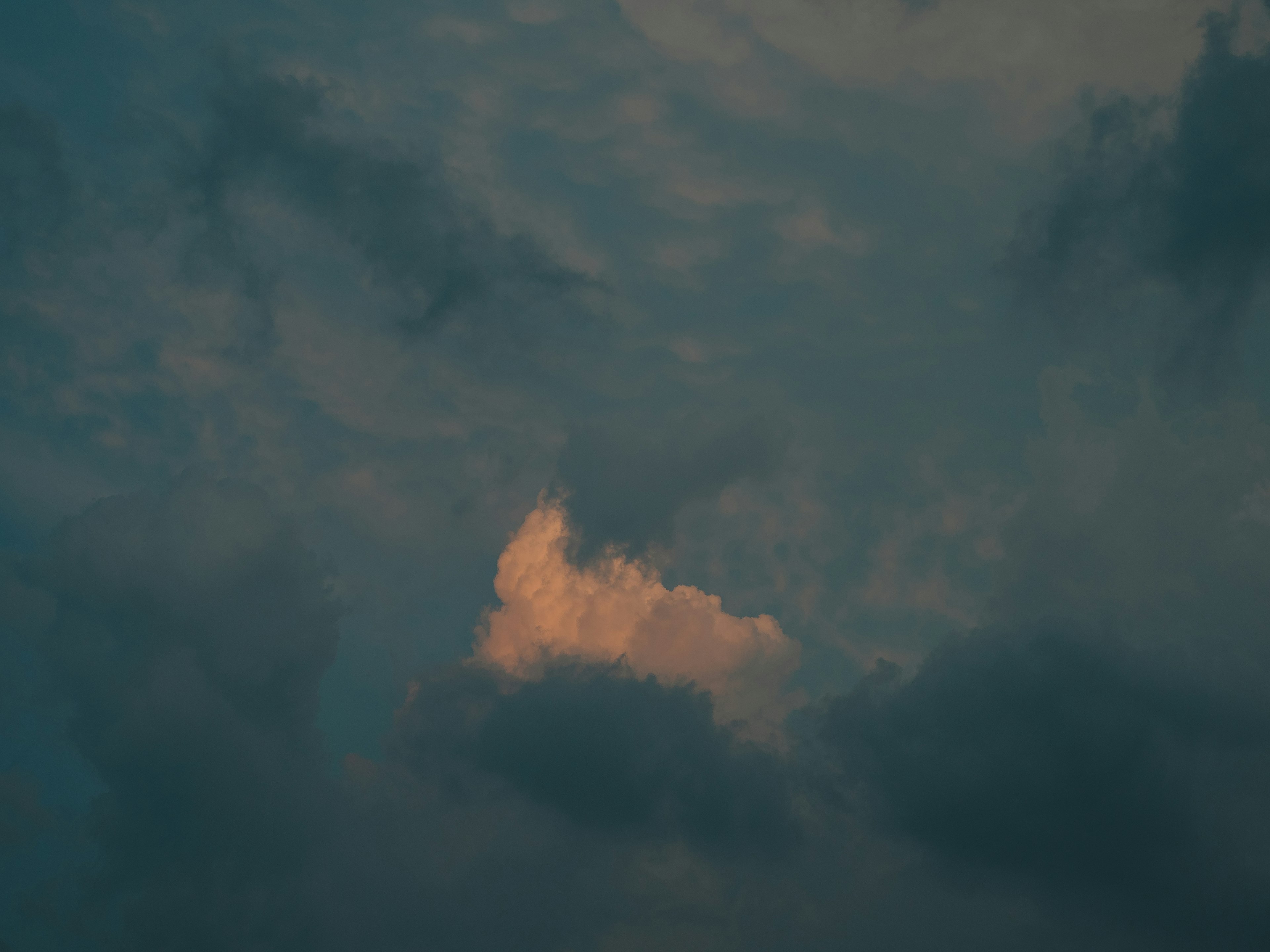 Orange cloud against a dark blue sky