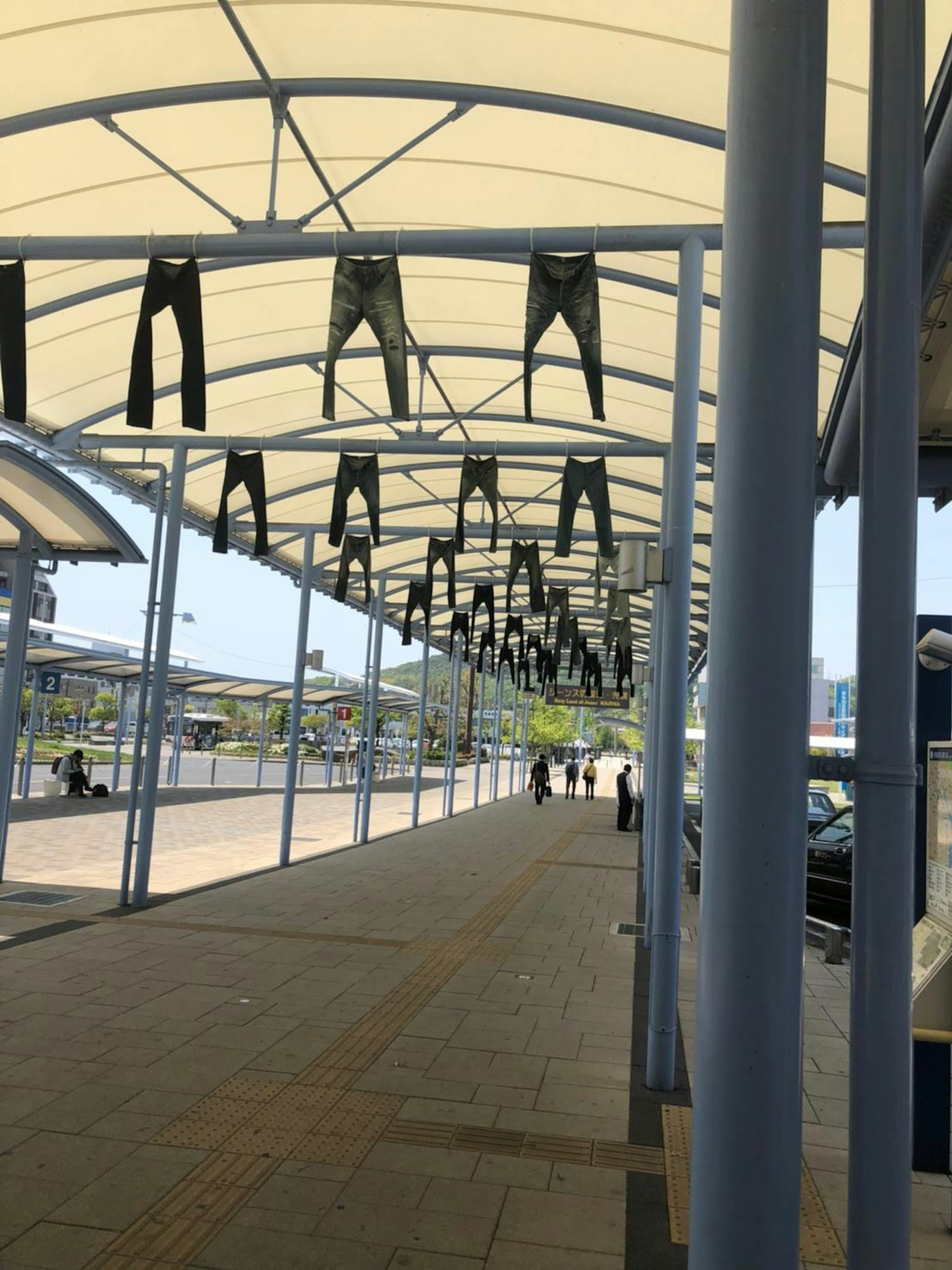 Vue d'un chemin avec des jeans suspendus sous un auvent