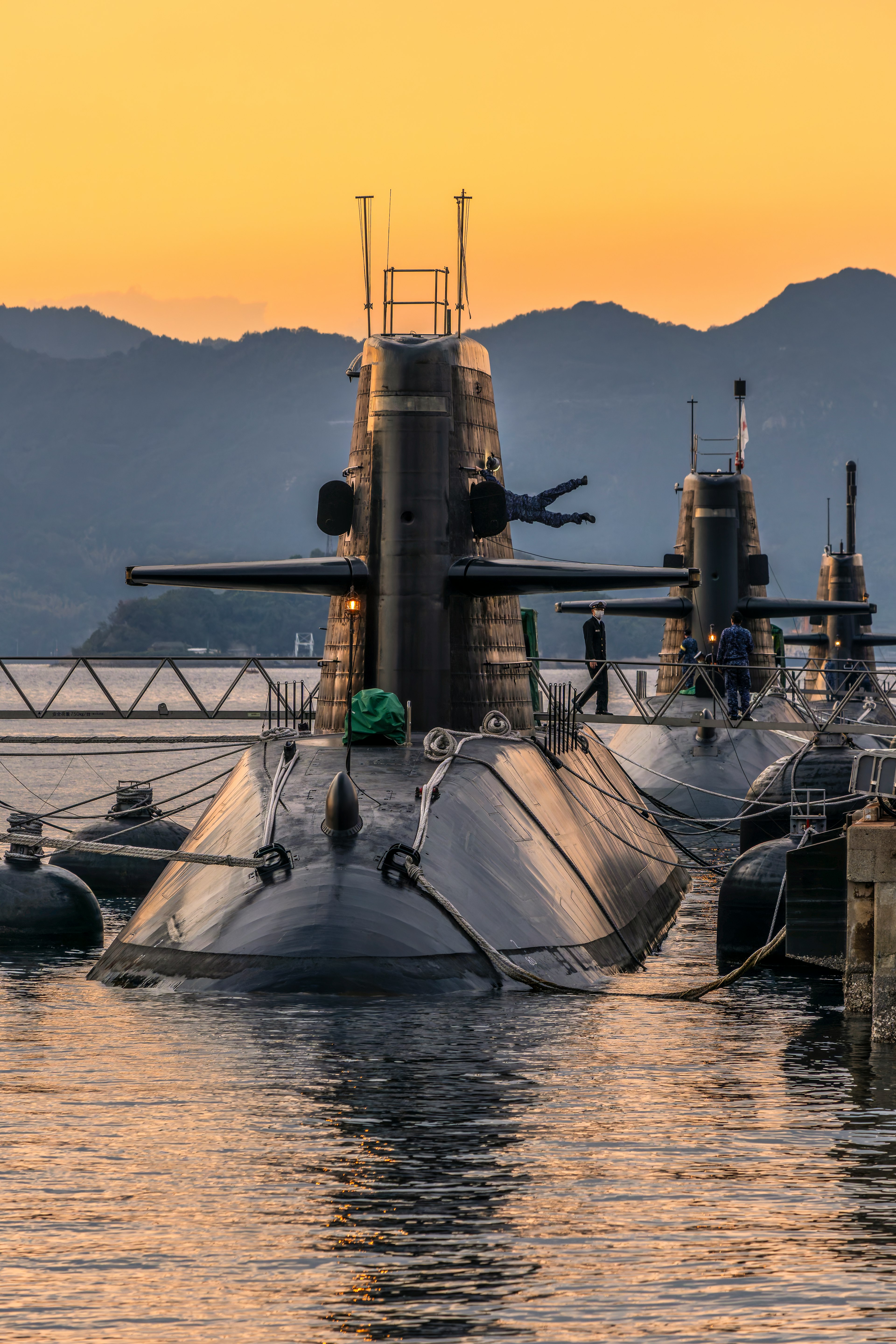 Submarine docked at port during sunset