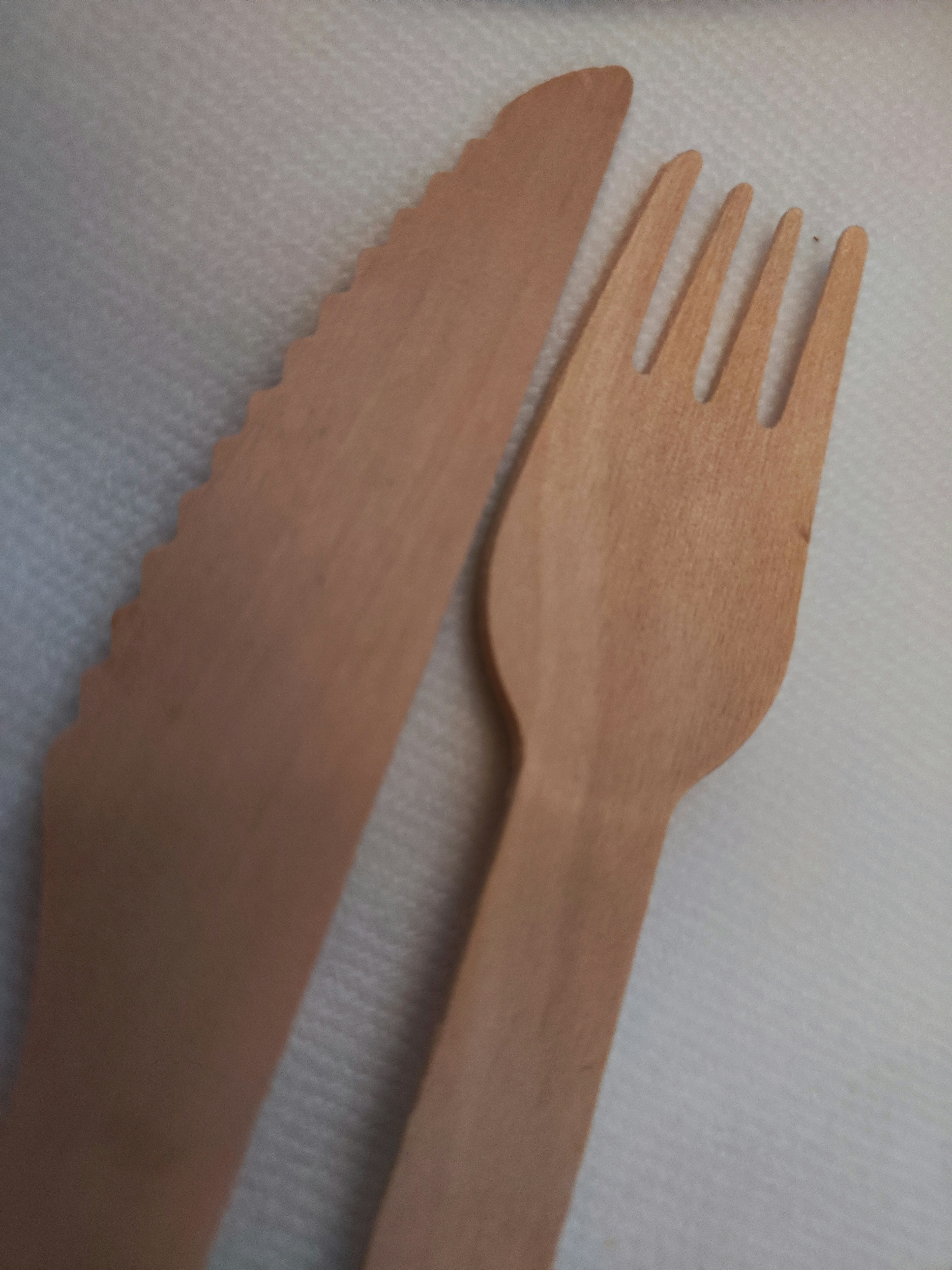 Wooden knife and fork placed on a white background