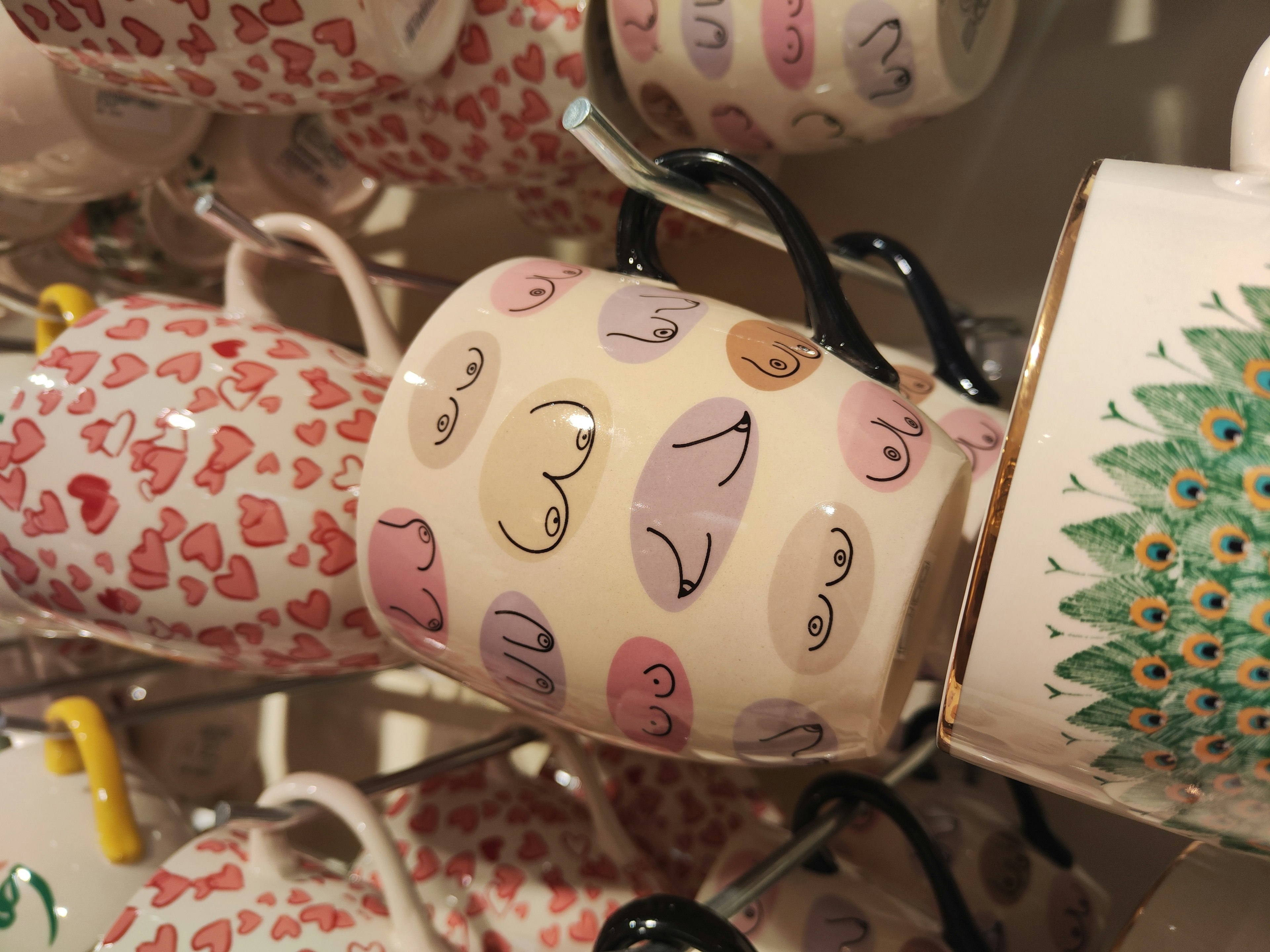 A collection of mugs featuring various designs with hearts and faces