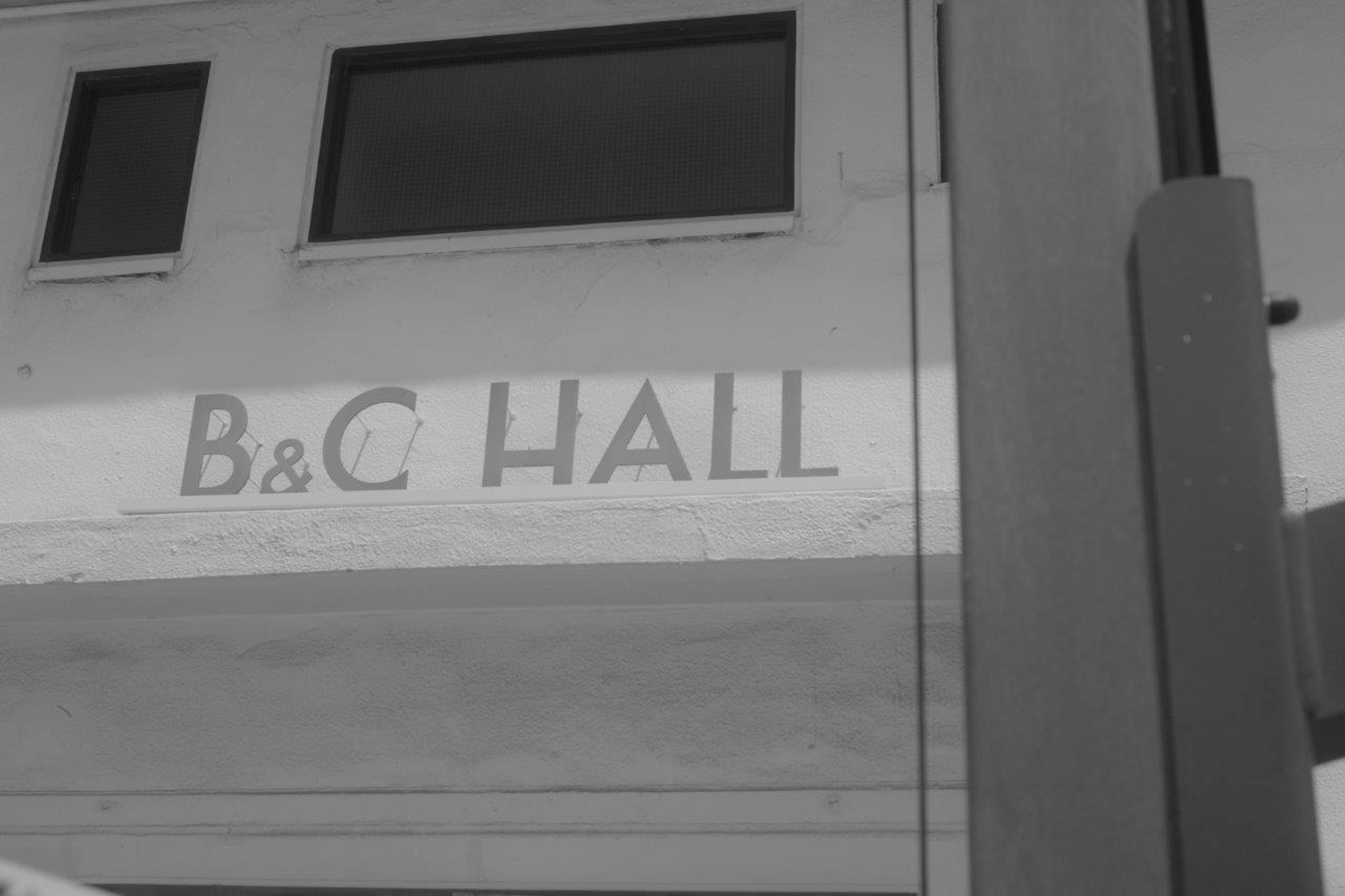 Black and white image showing the sign for B&C Hall