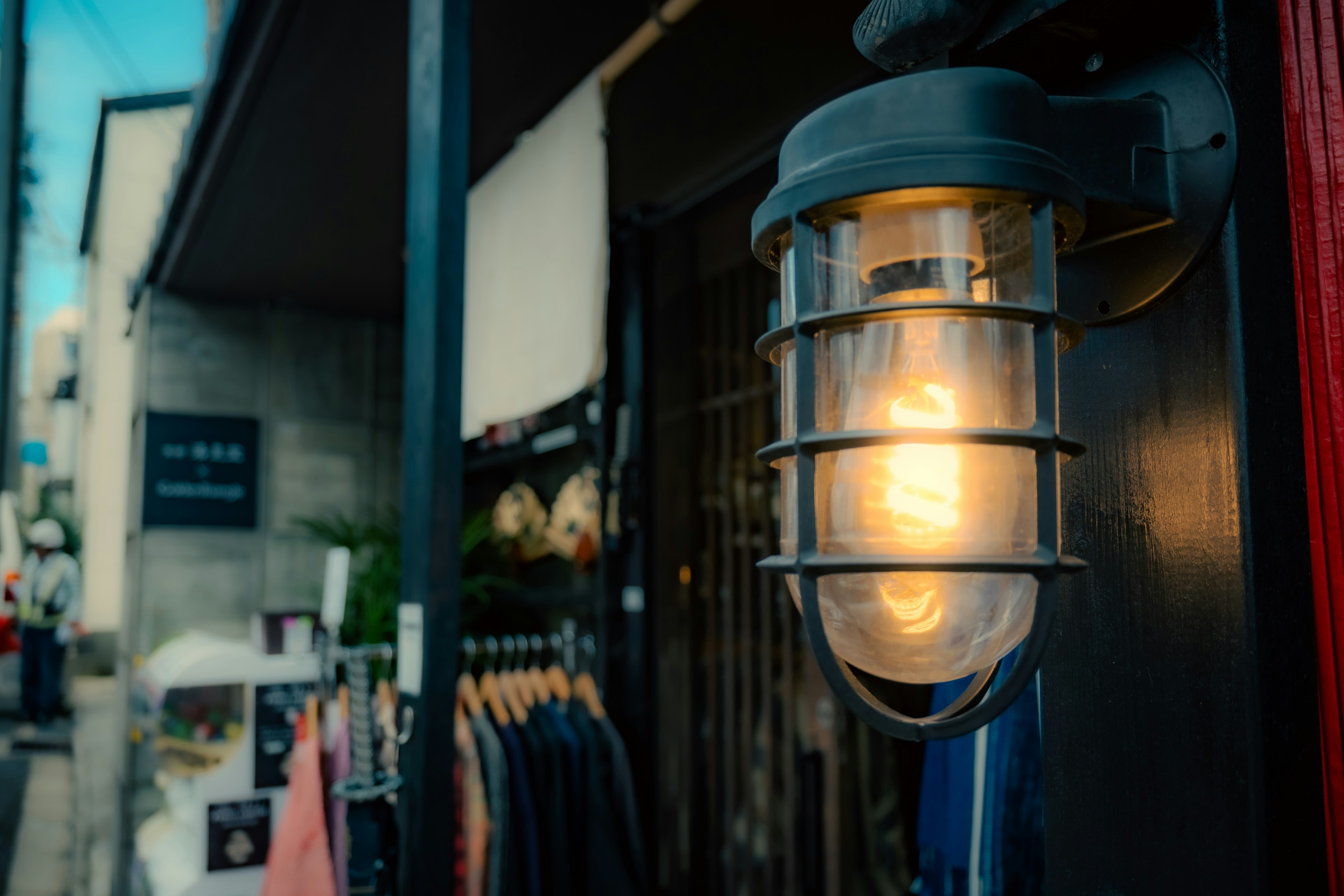 Metal lamp with warm light outside a store