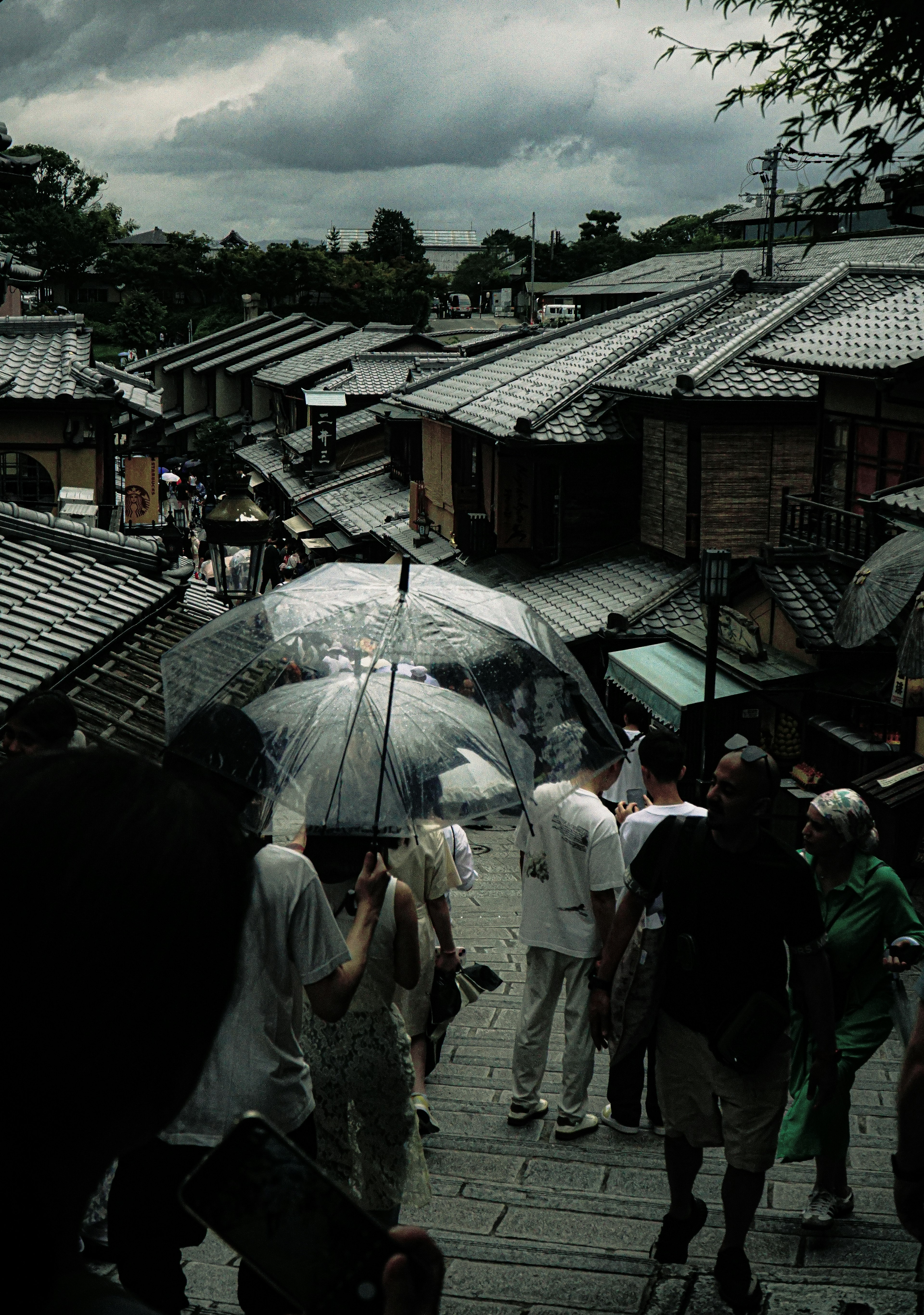 Old streets with people holding umbrellas in the rain