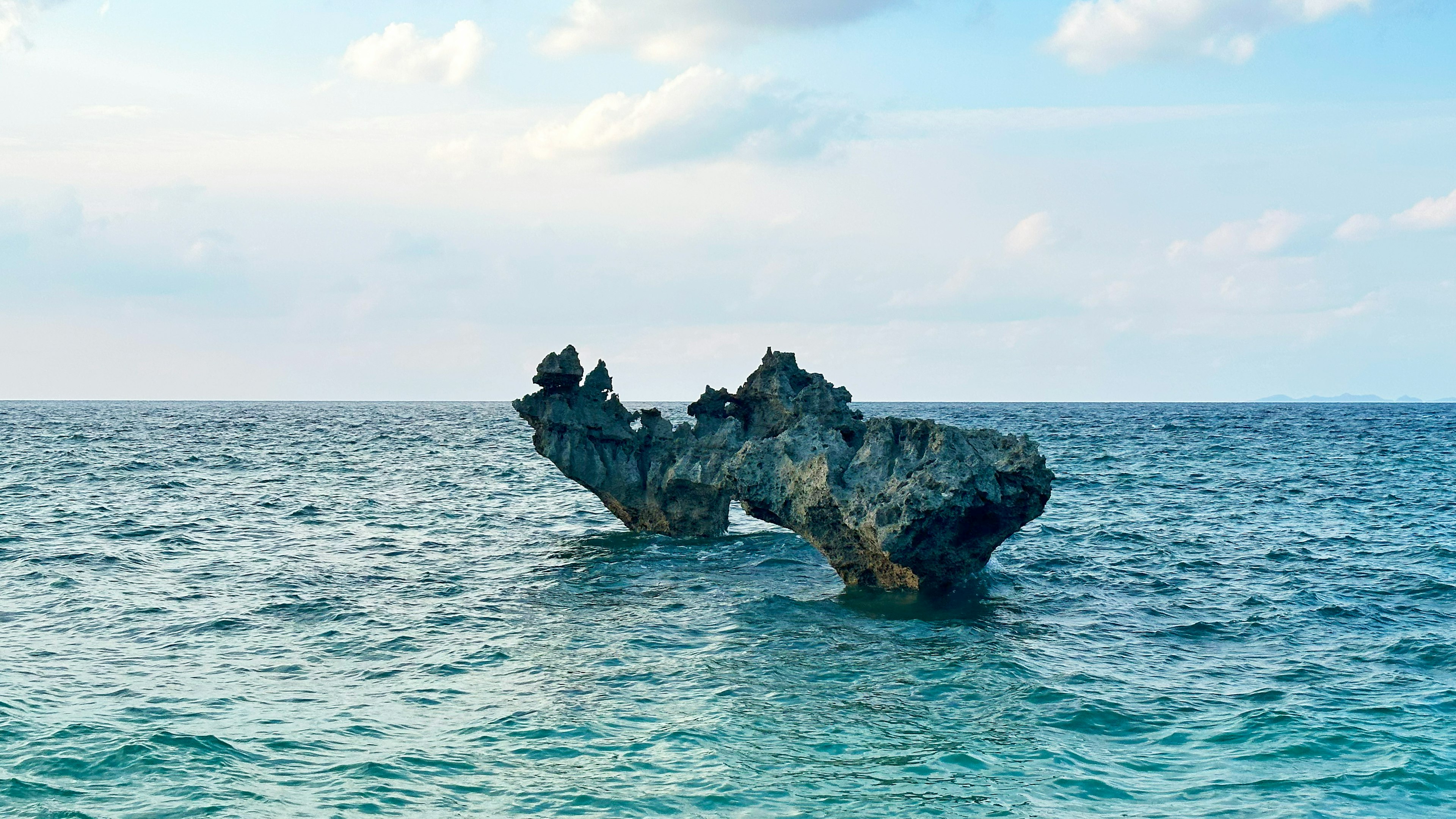 Unique shaped rock emerging from the ocean