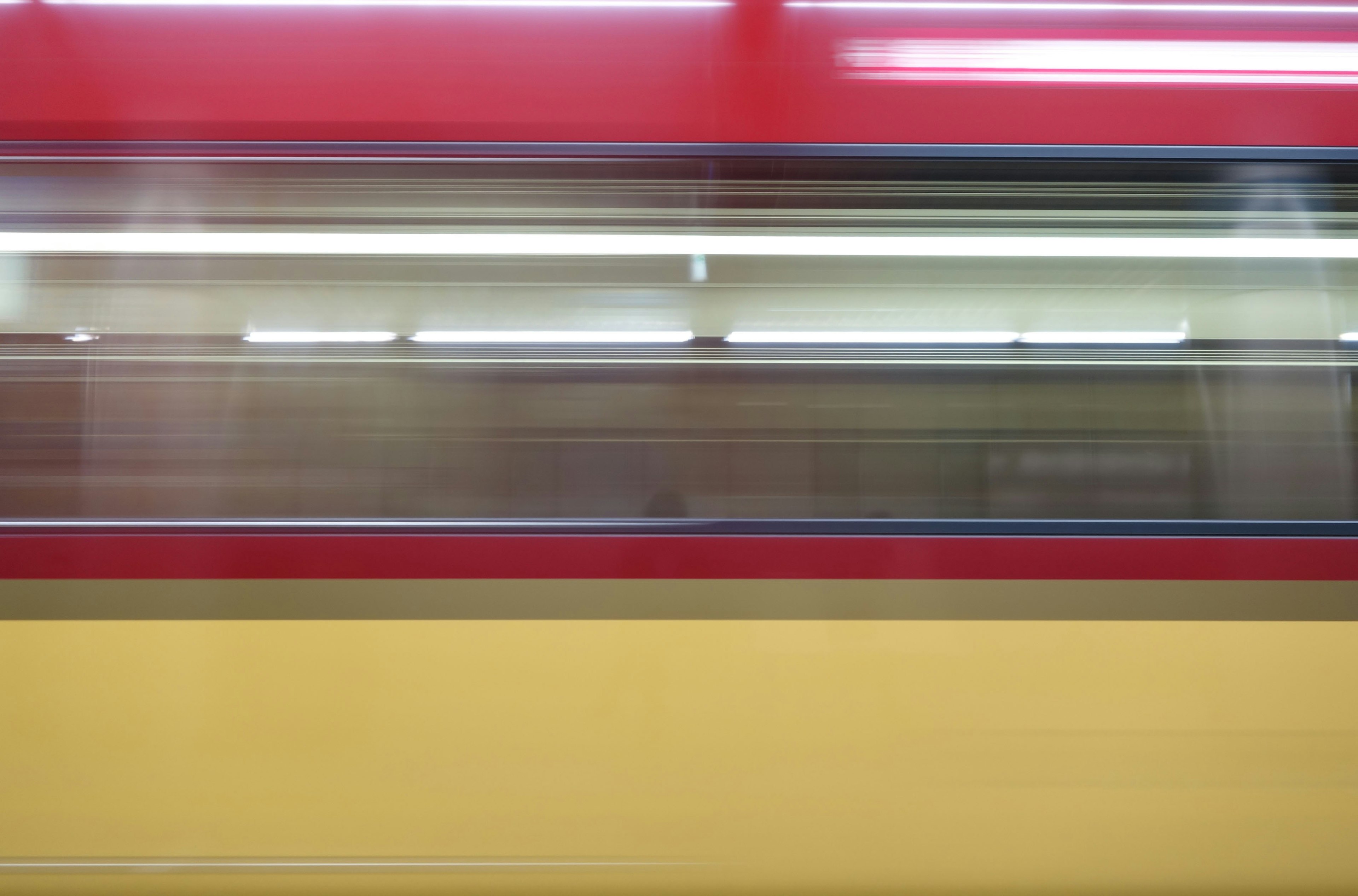 A red and yellow train in motion