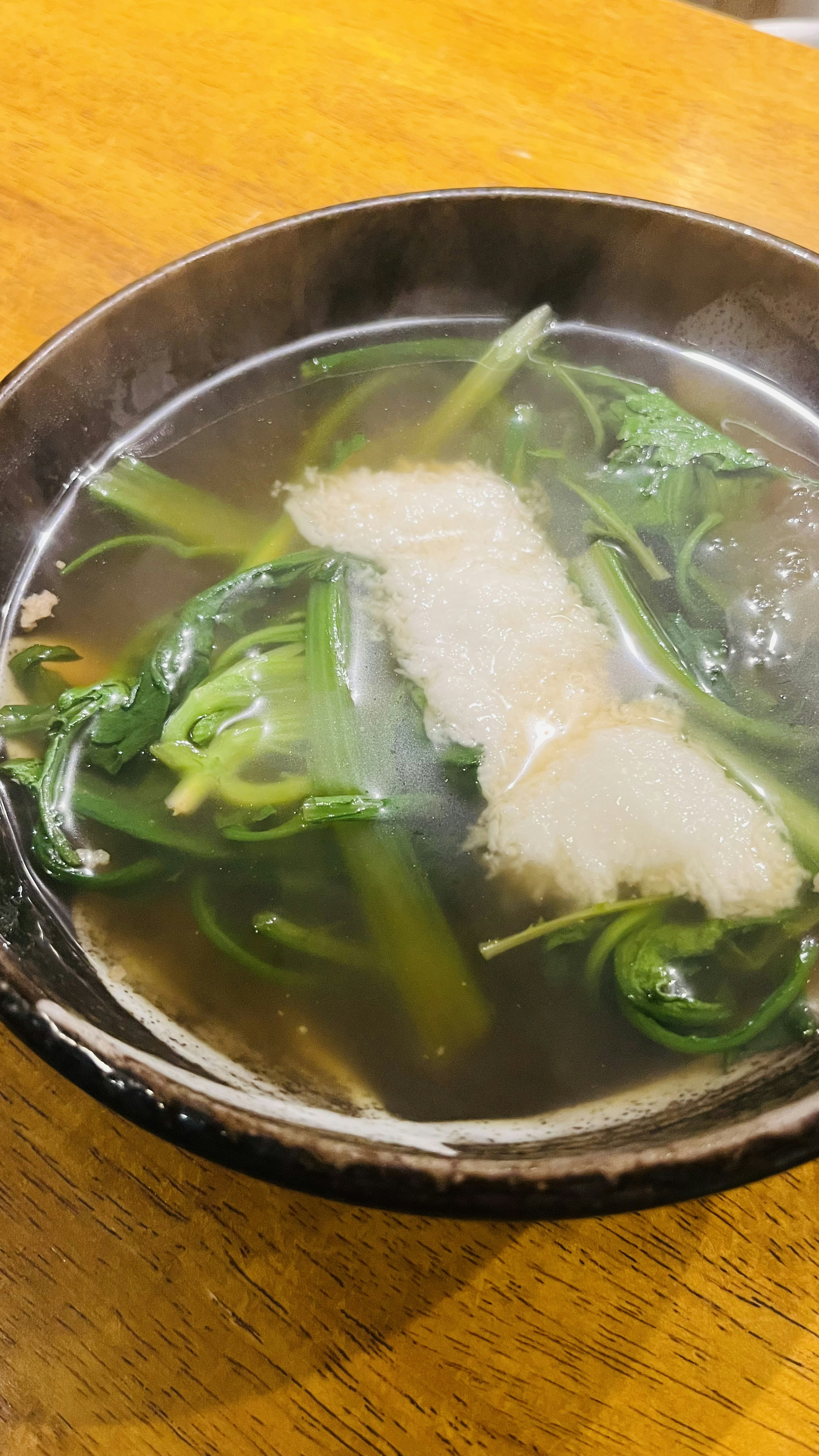 熱々のスープに新鮮な野菜と白身魚が浮かんでいる