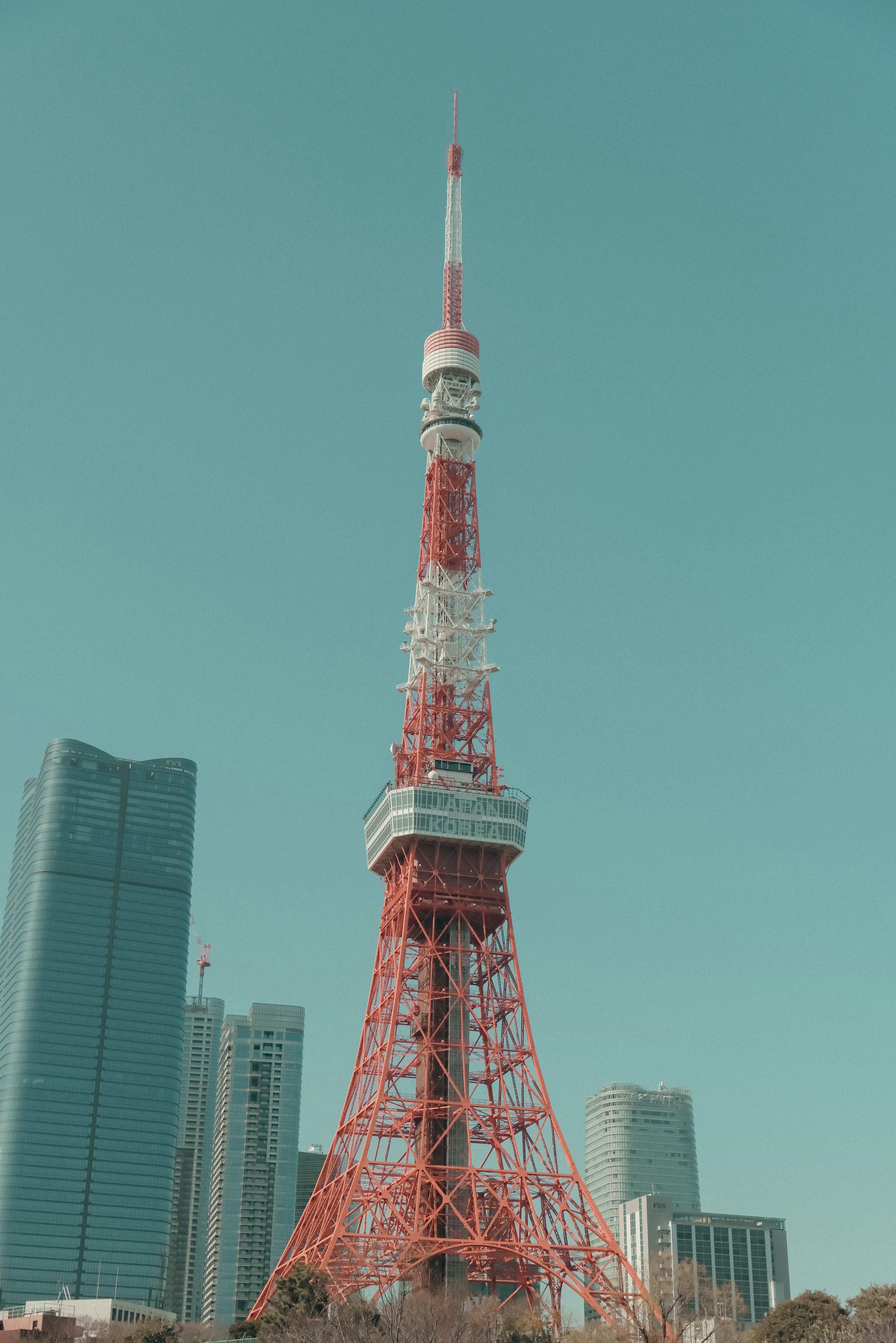 Tokyo Tower with red and white structure towering under a blue sky