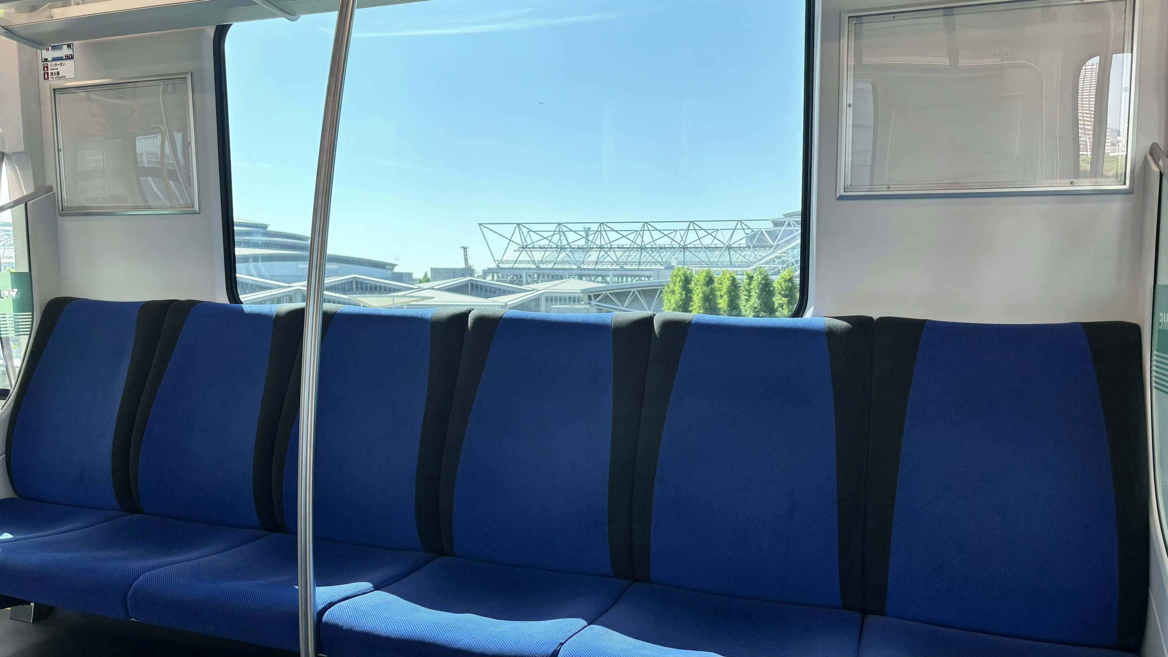 Interior view of public transportation featuring blue seats