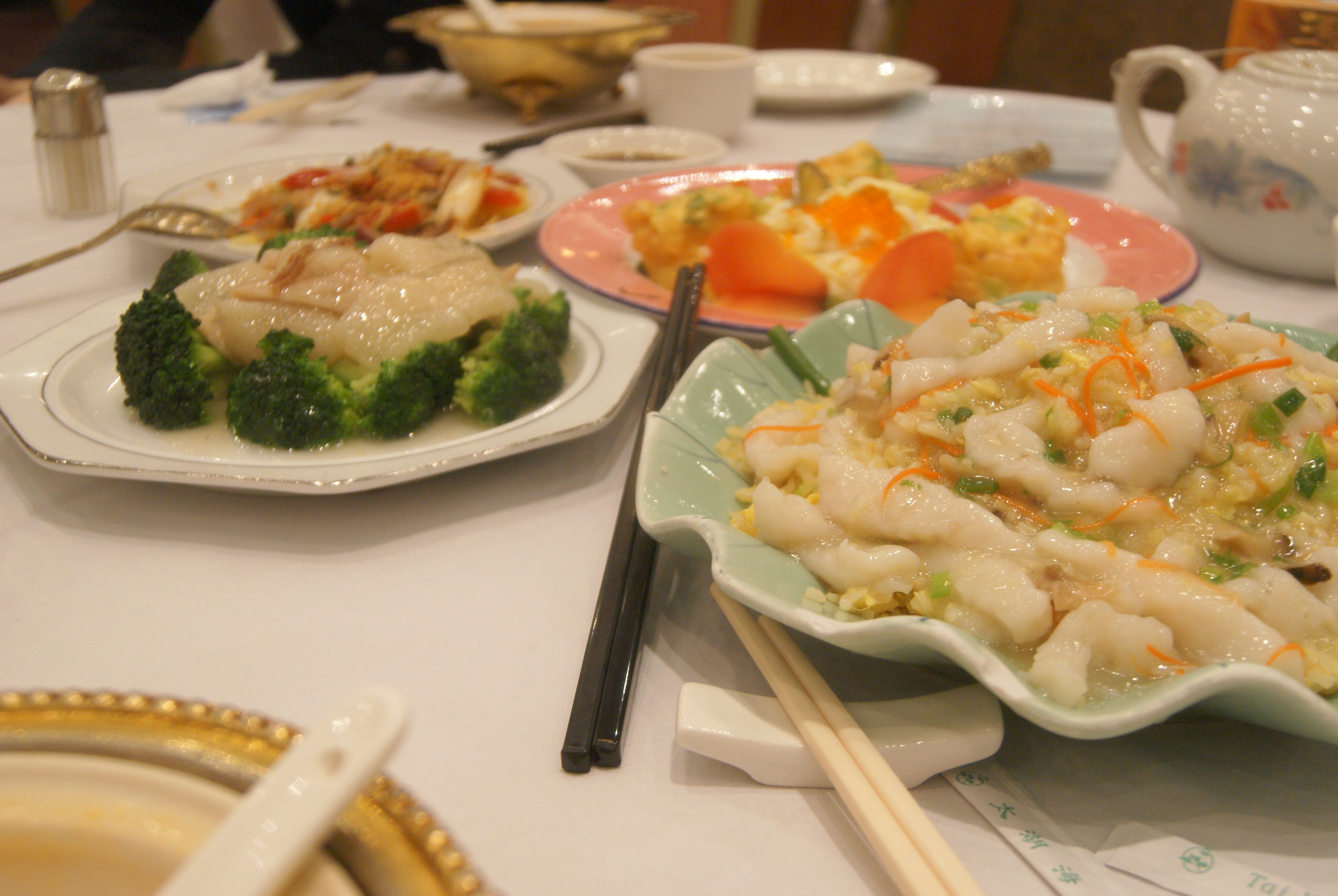 A spread of Chinese dishes on a dining table