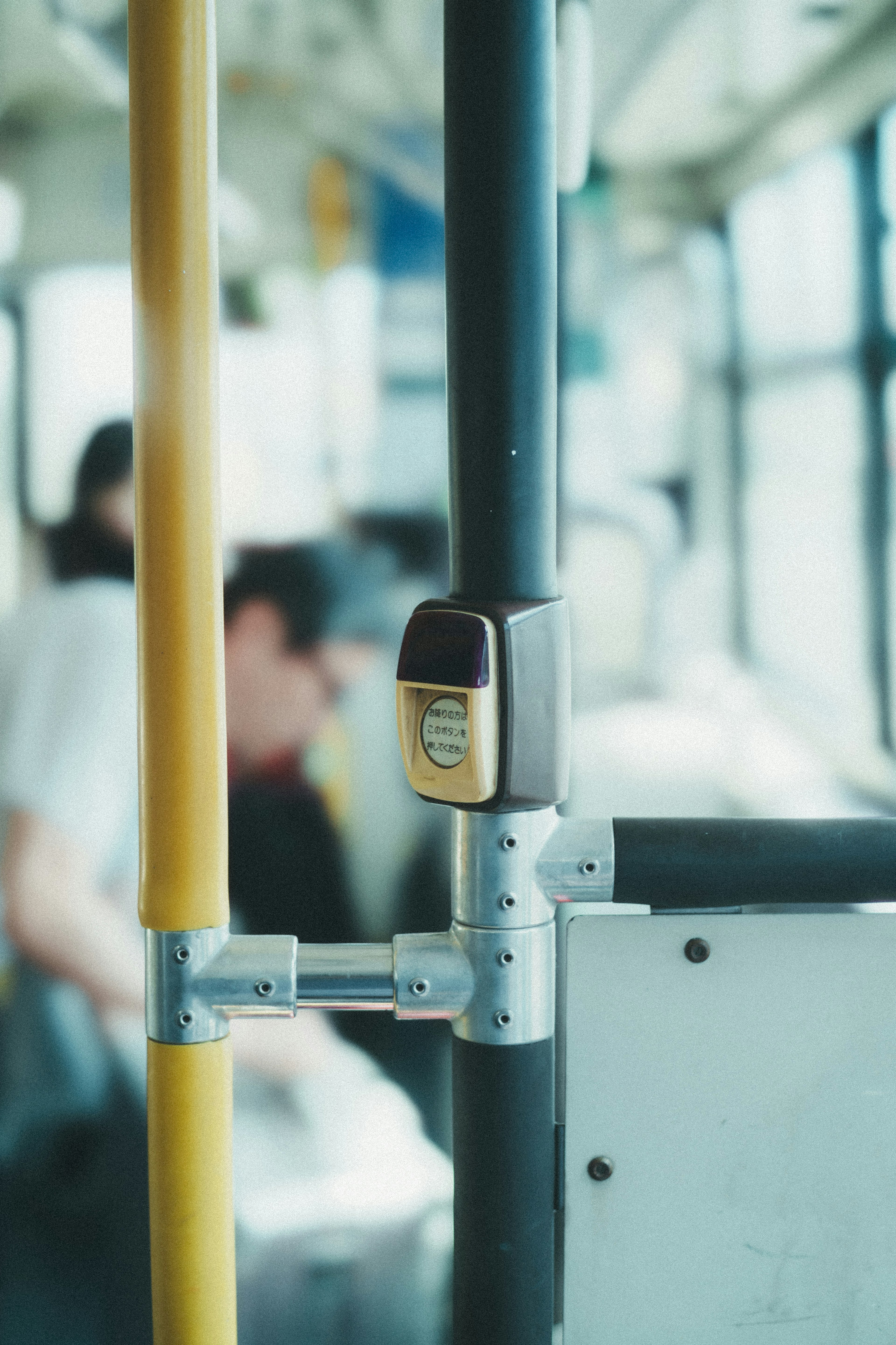 Close-up of bus interior handrail with a padlock