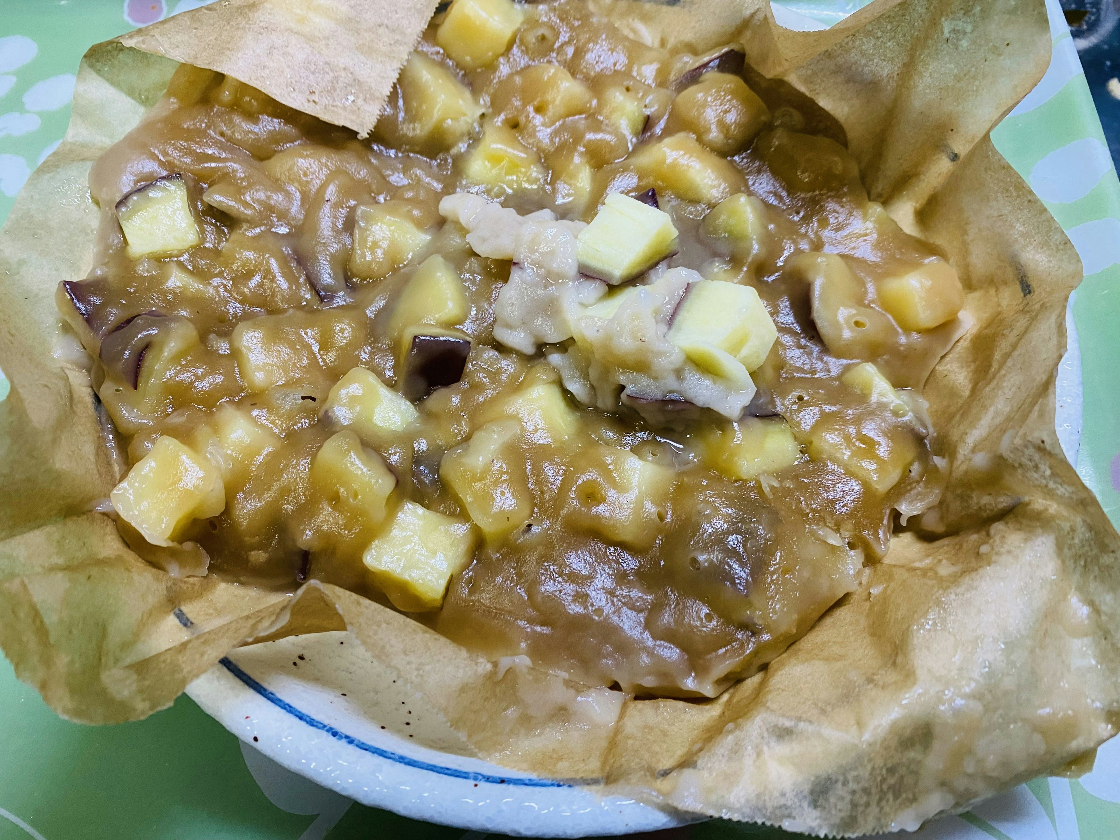 Postre de manzana caramelizada caliente servido en un tazón con manzanas en cubos y salsa de caramelo