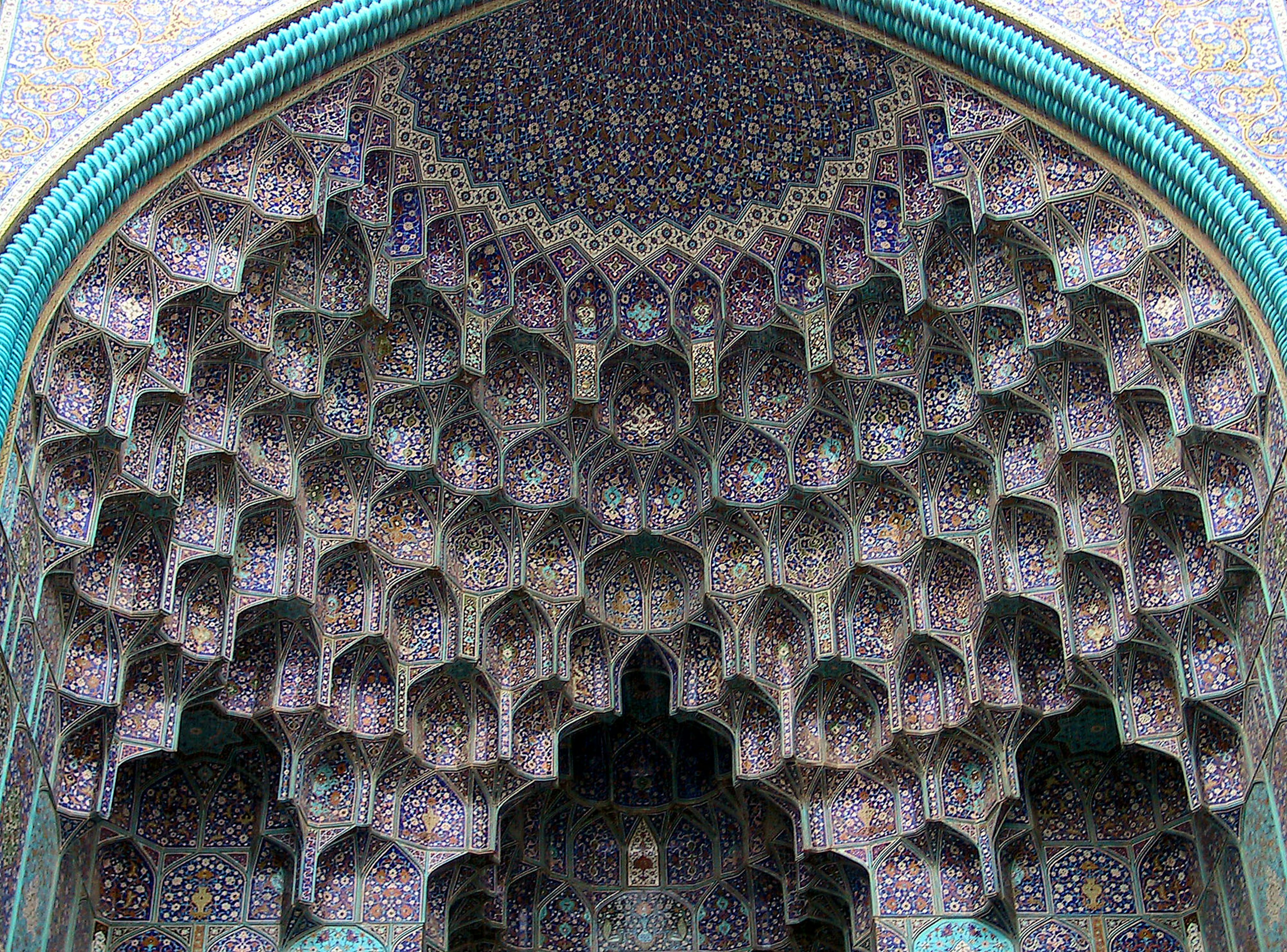 Intricate mosaic patterns of Islamic architecture within an arch