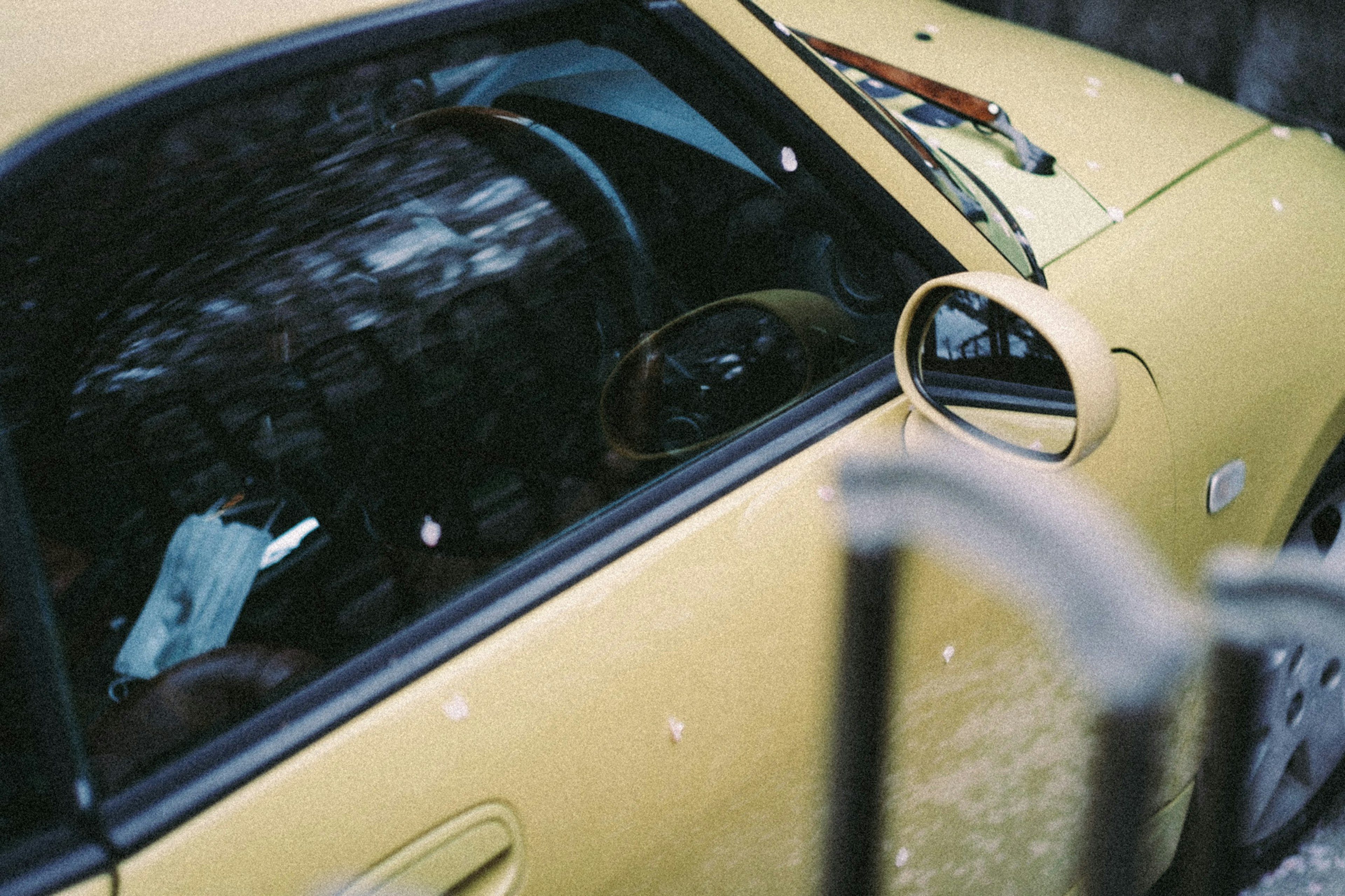 Close-up of a yellow car showing interior details and exterior features