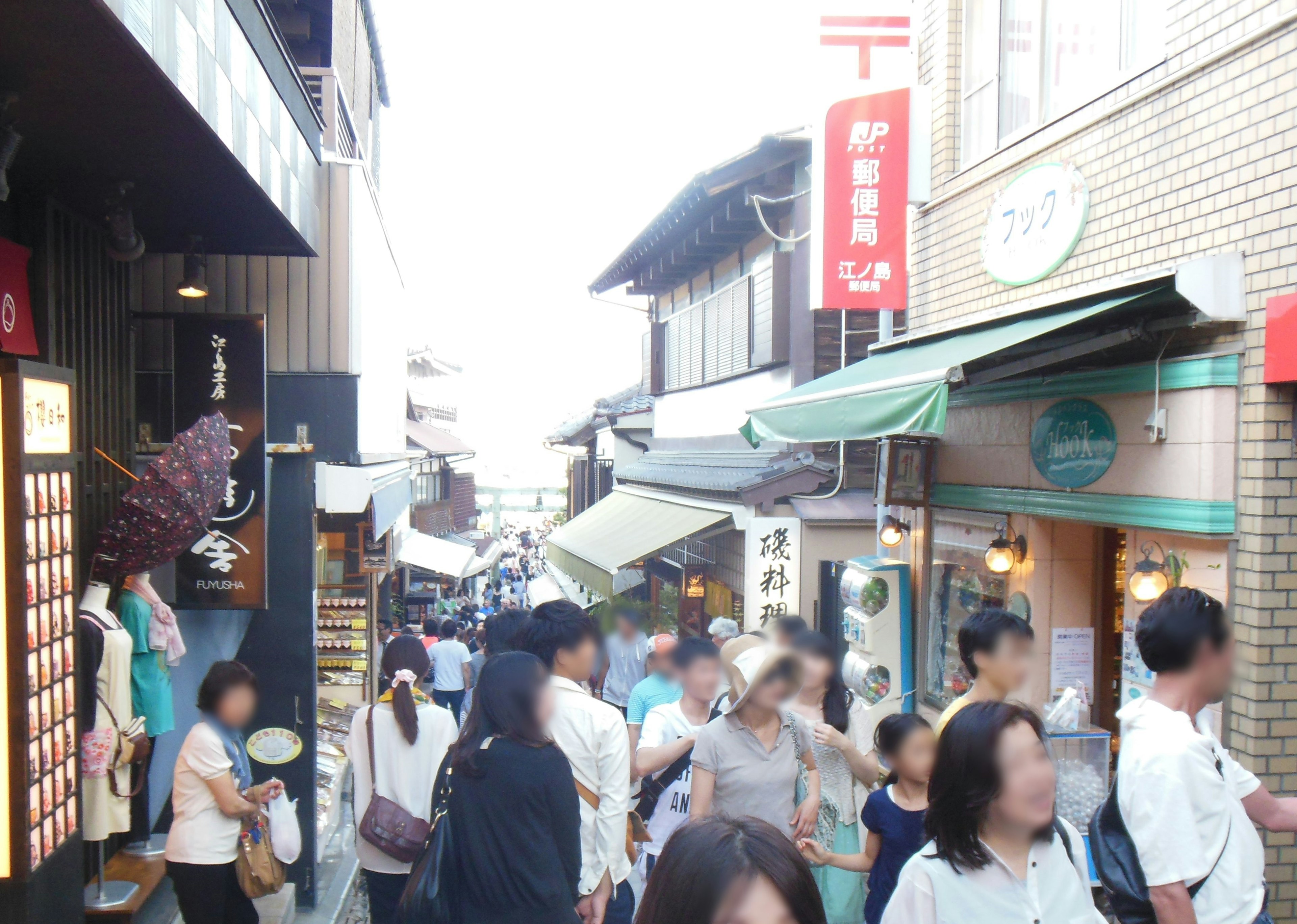 Busy street scene with people walking shops and restaurants lining the area