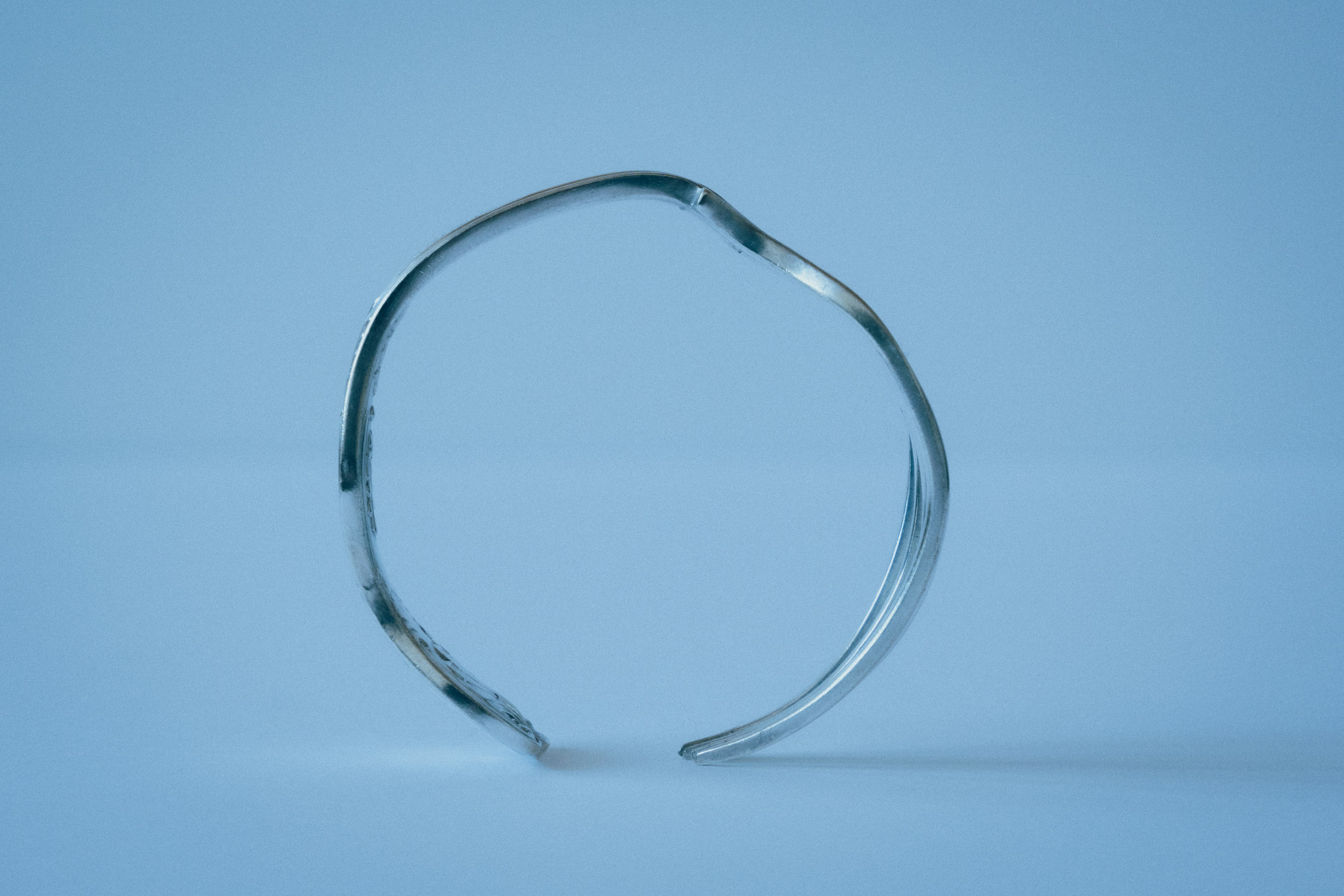 Image of a metallic ring against a blue background