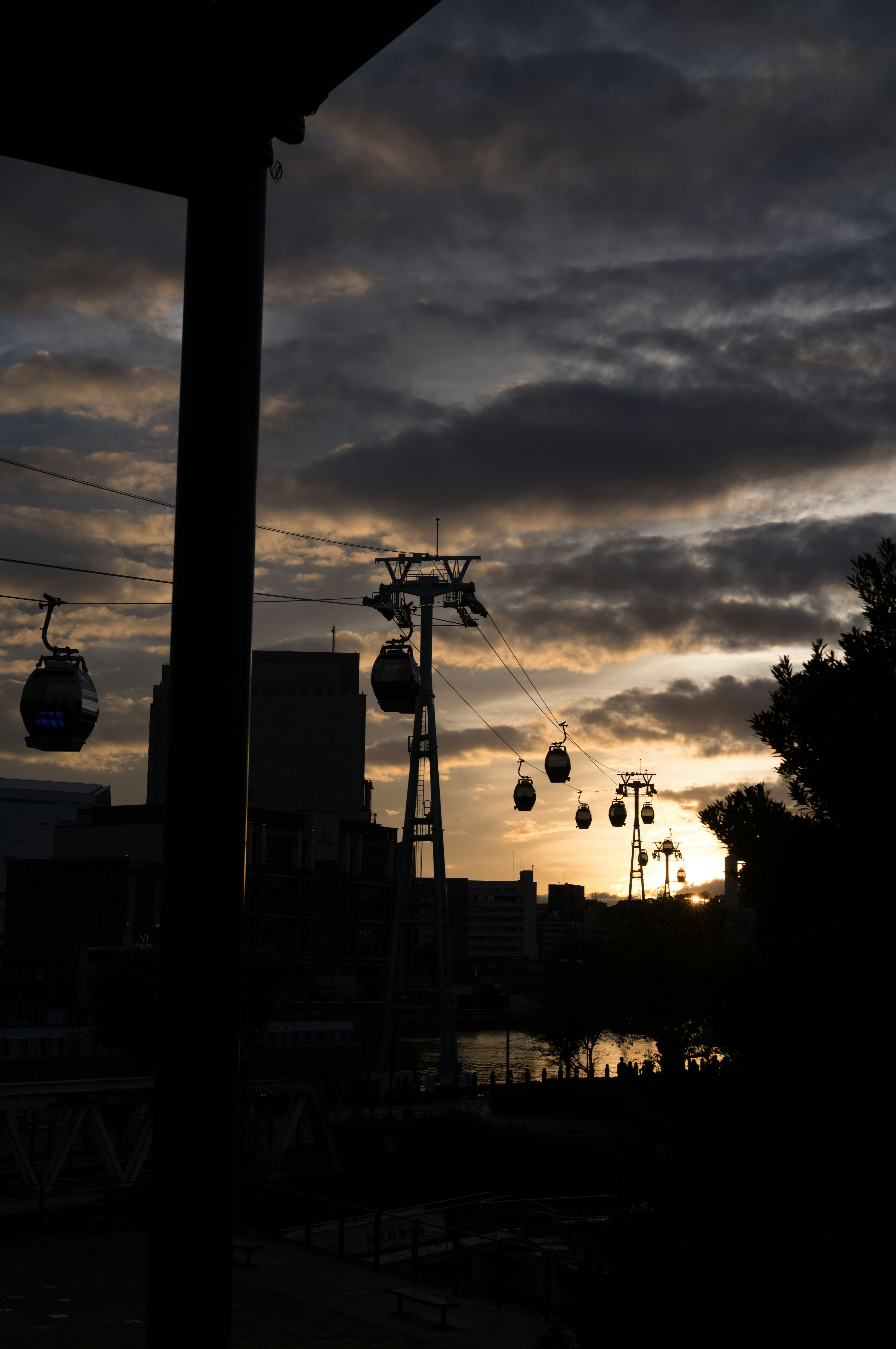 夕日を背景にしたケーブルカーのシルエットと雲