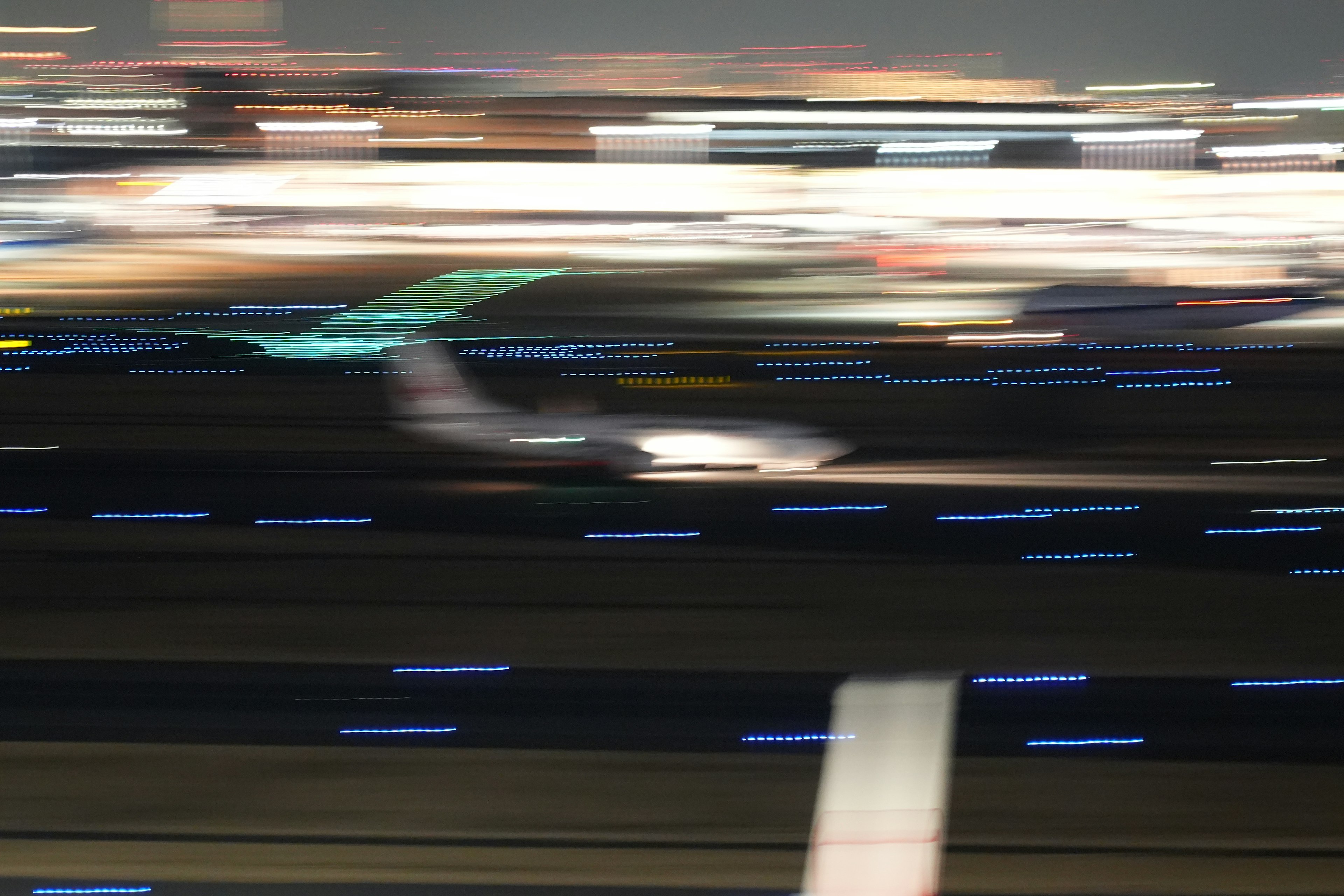 Blurred image of an airplane taxiing on the runway at night