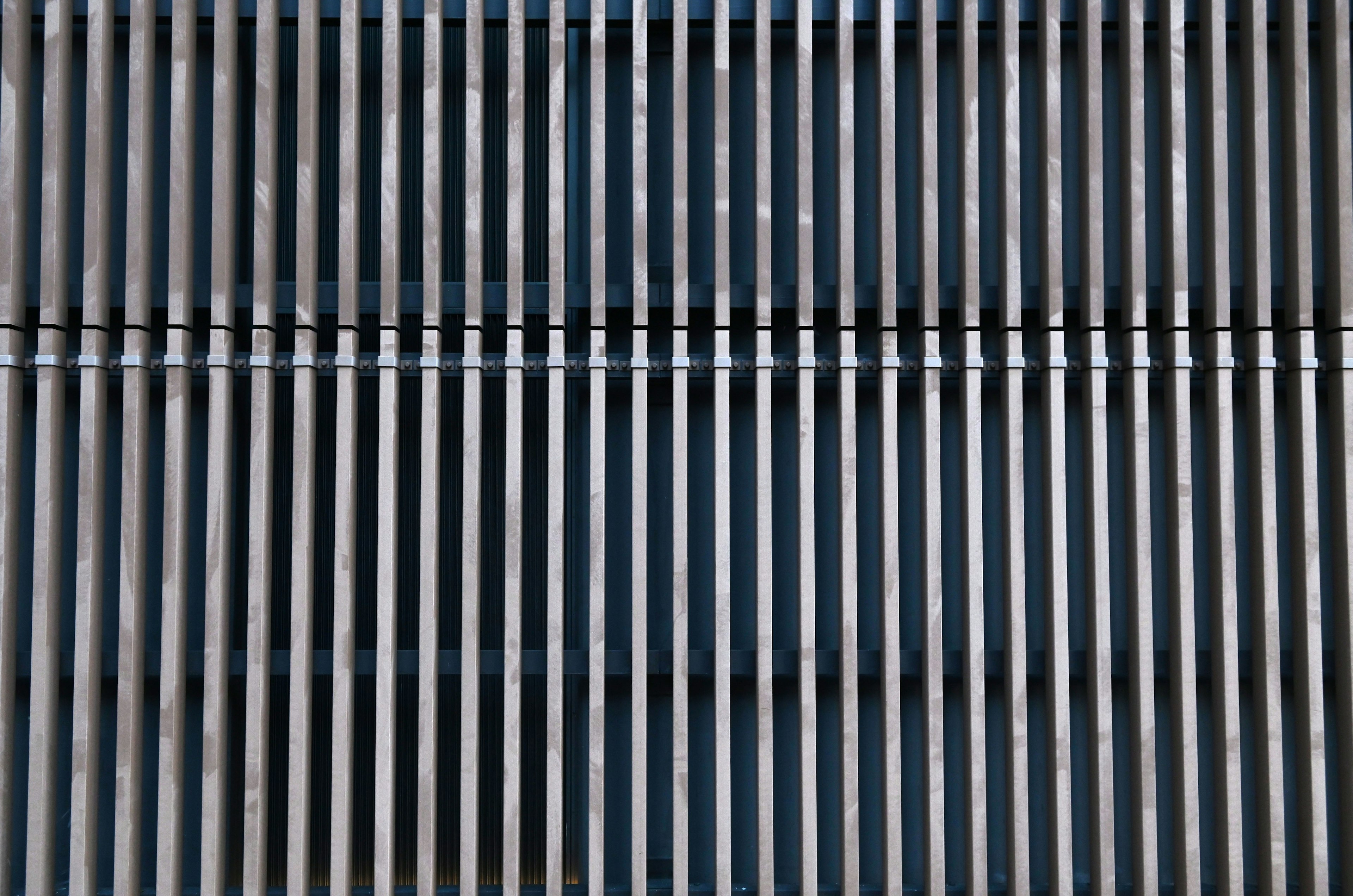 Metal grid pattern with alternating blue and black stripes