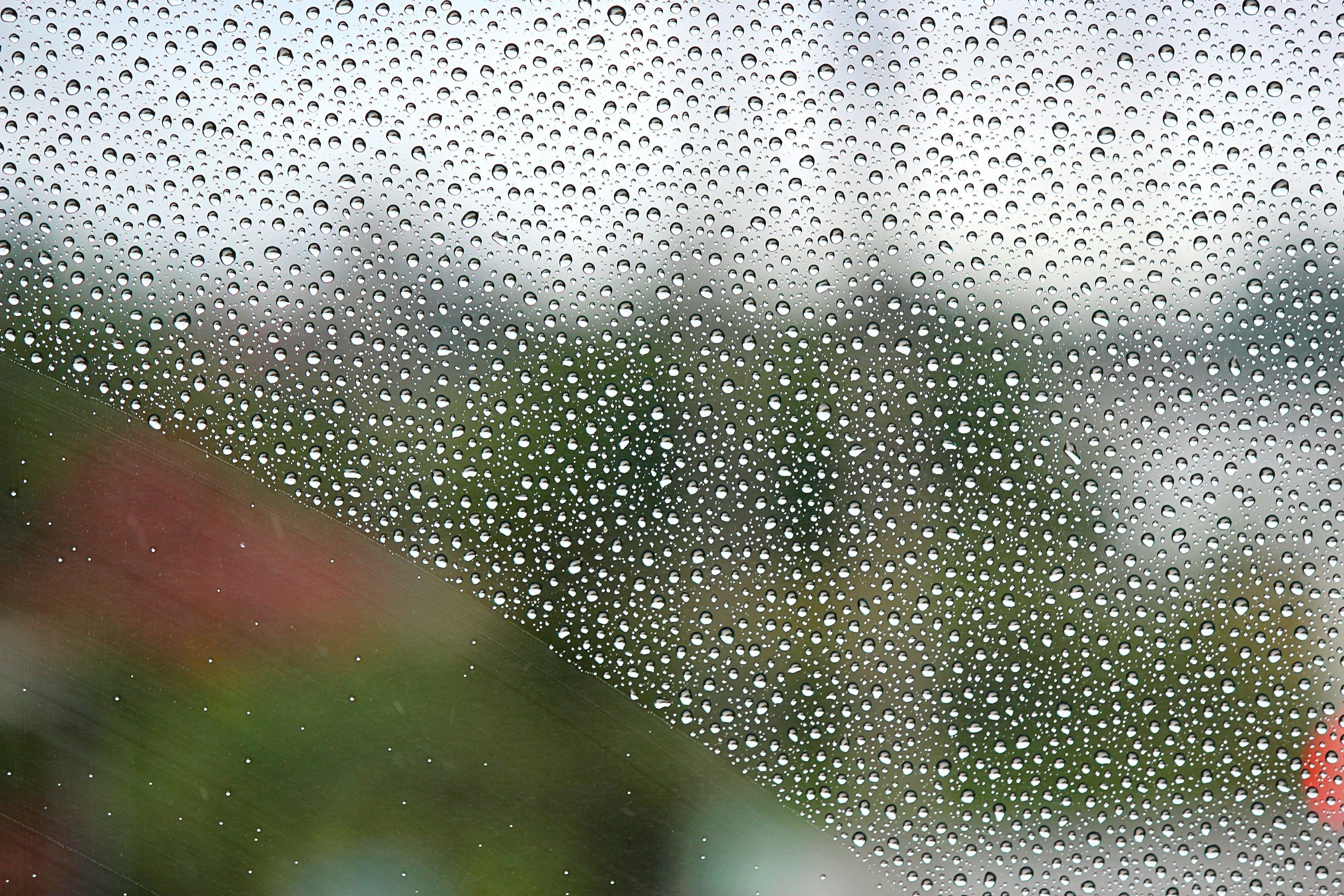 Close-up of raindrops on a window with a blurred background