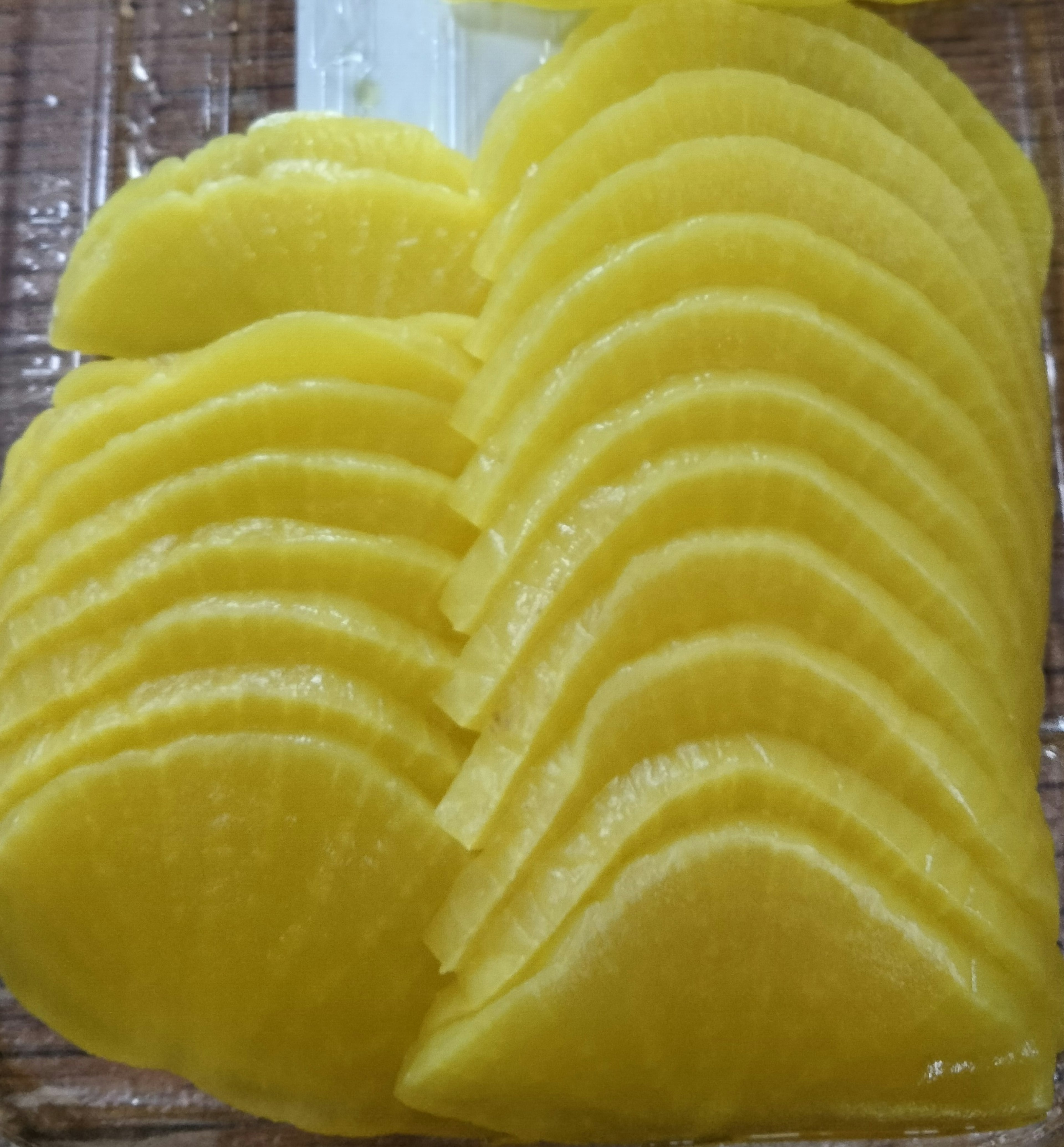 Thinly sliced yellow radish arranged neatly