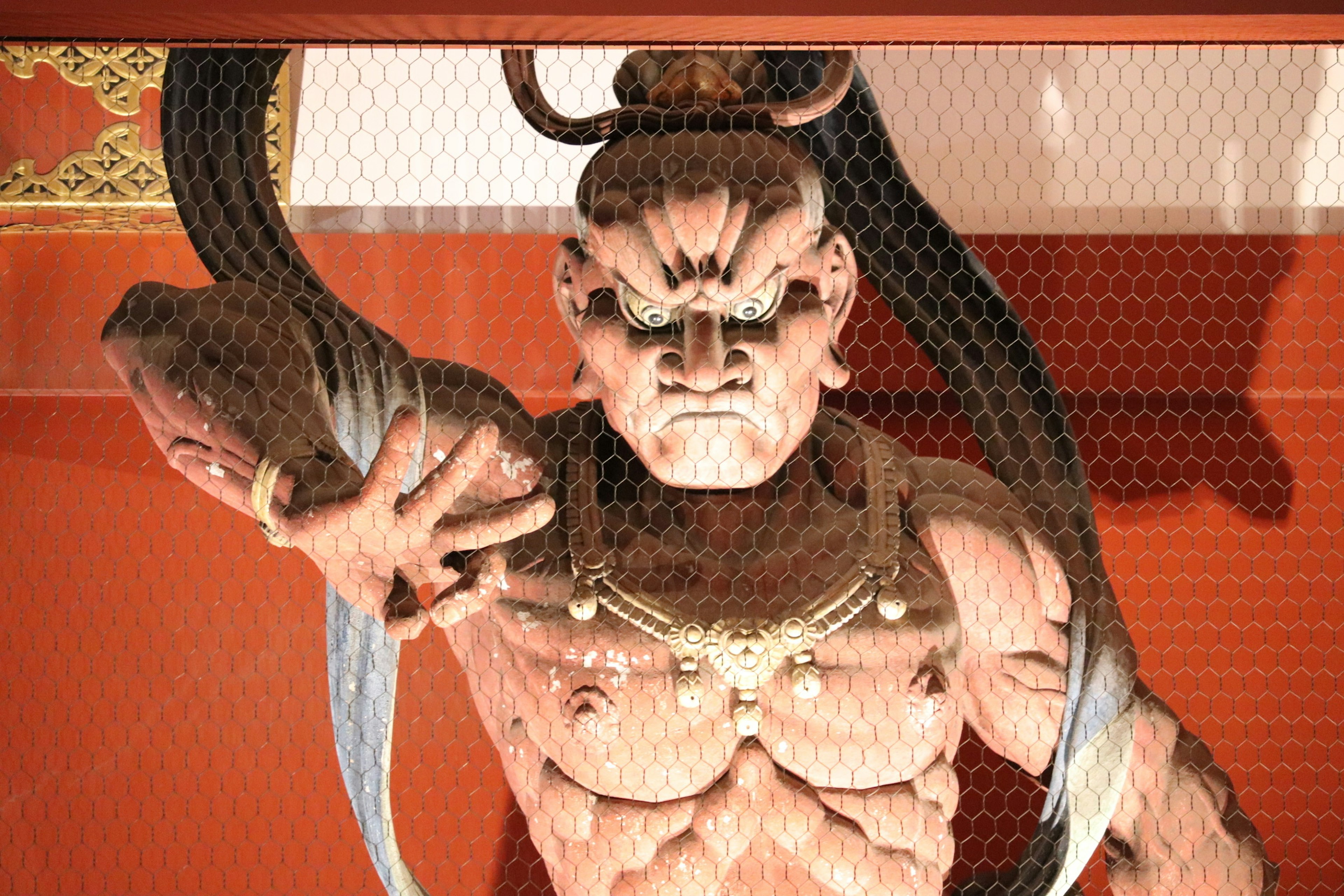 Statue of a demon from a shrine with a fierce expression and muscular physique