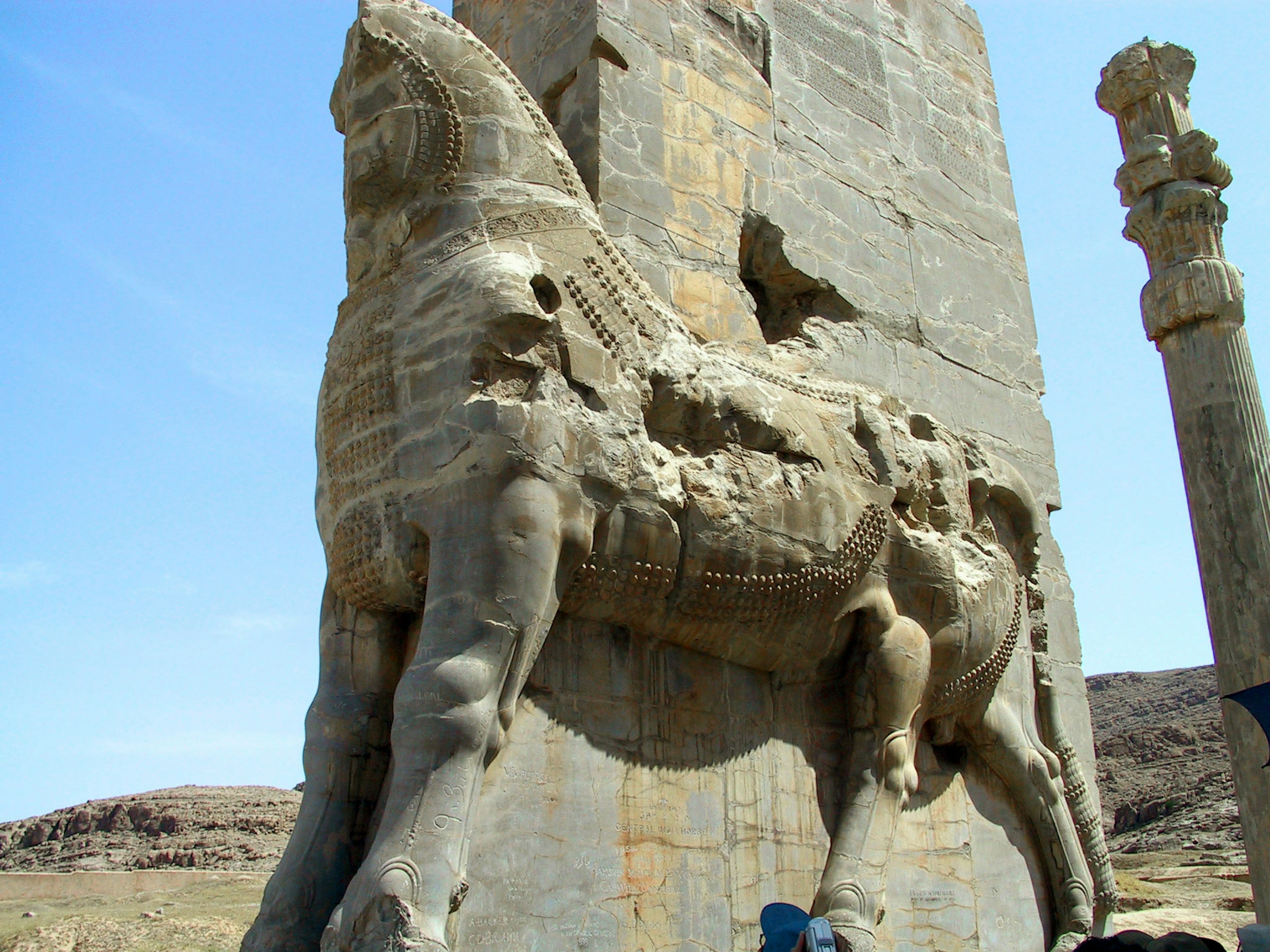 Scultura di cavallo in pietra antica con rovine sullo sfondo