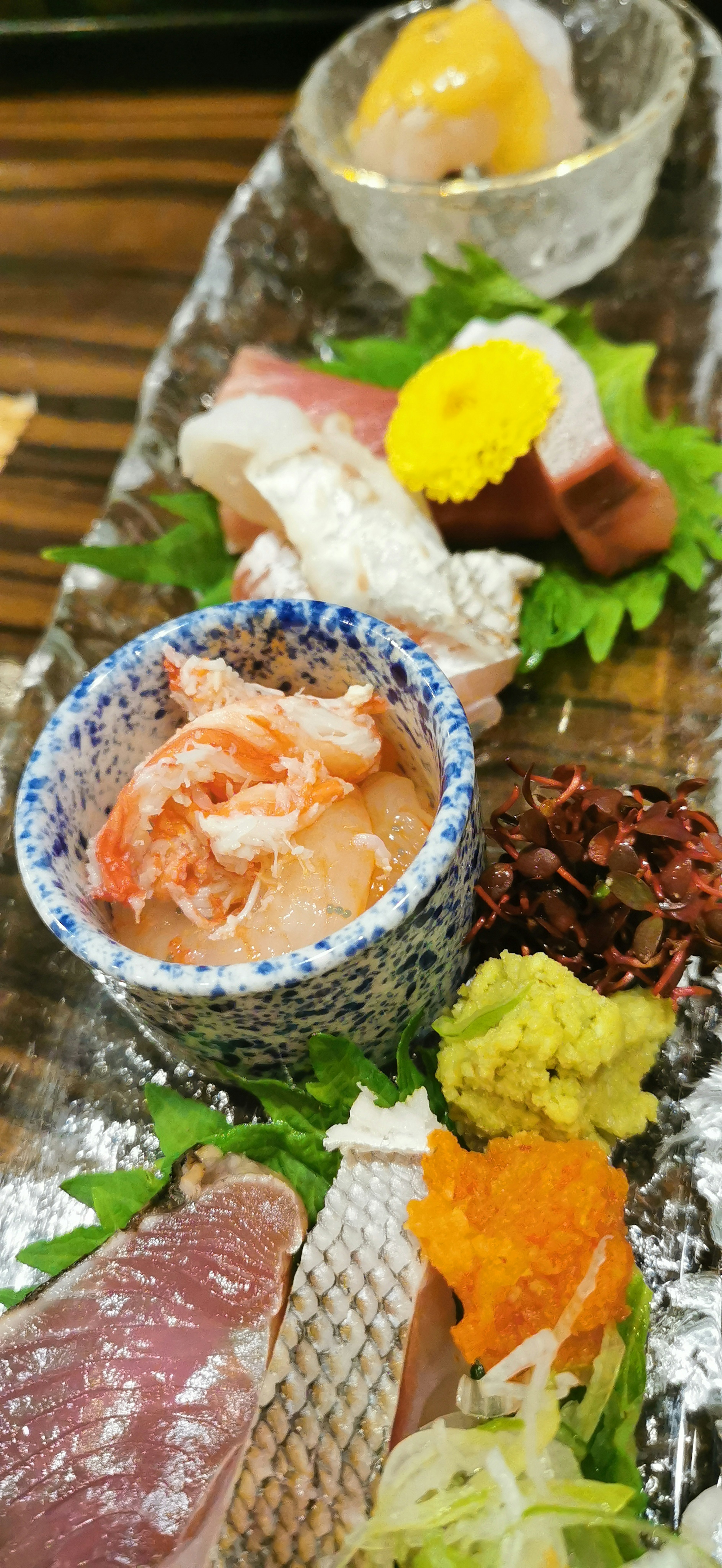 A plate of assorted sashimi with wasabi and garnishes