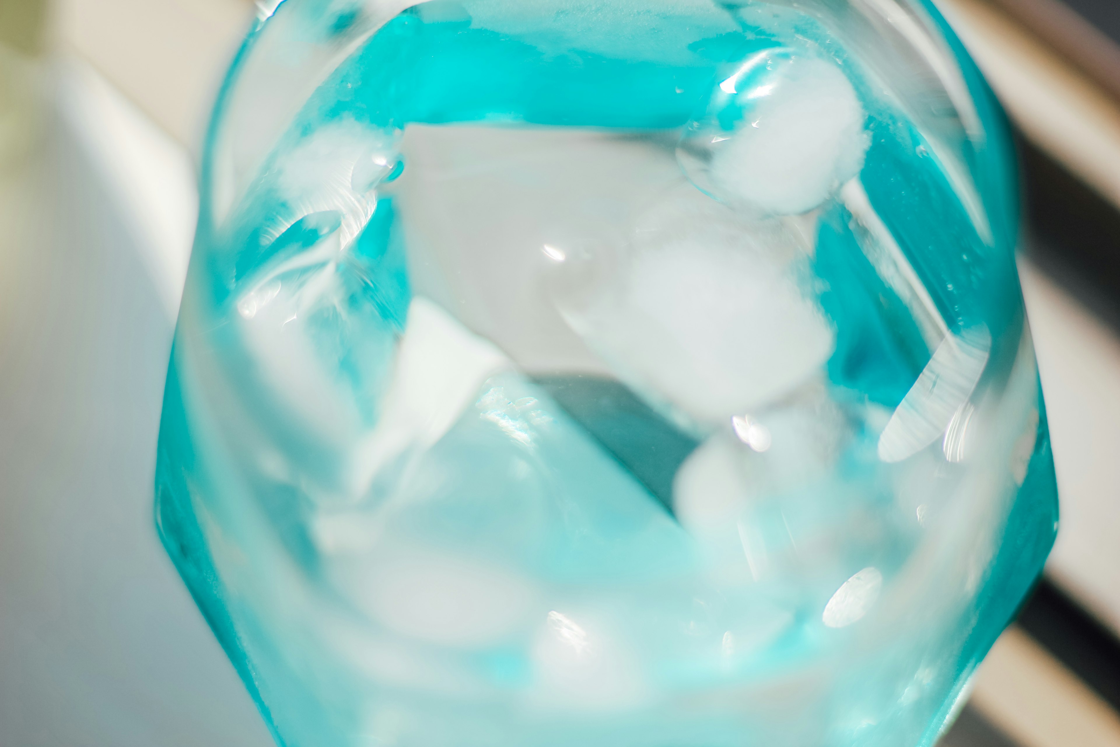 Image of blue liquid with white ice cubes floating inside