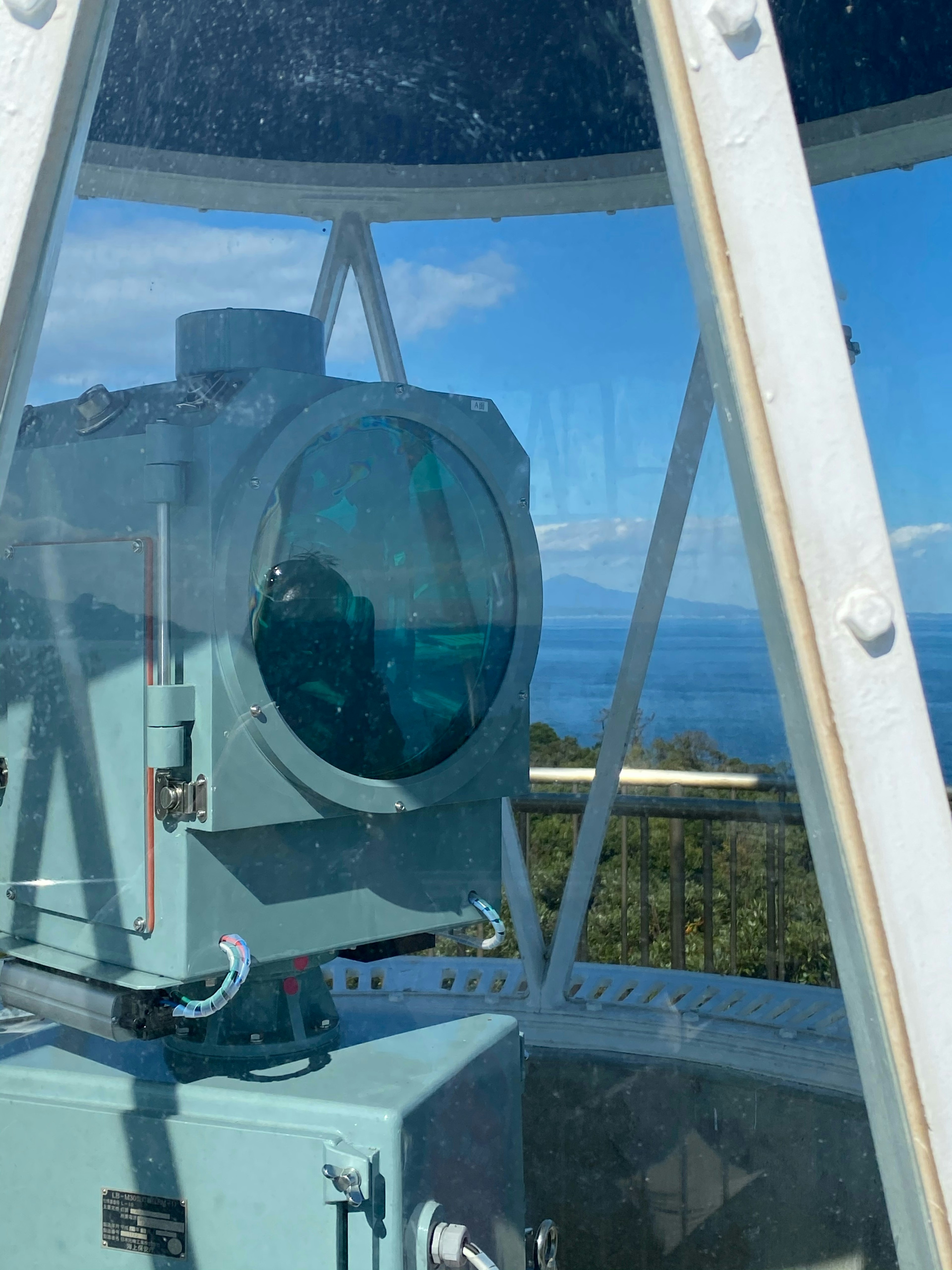 Lighthouse lens with blue glass and ocean view