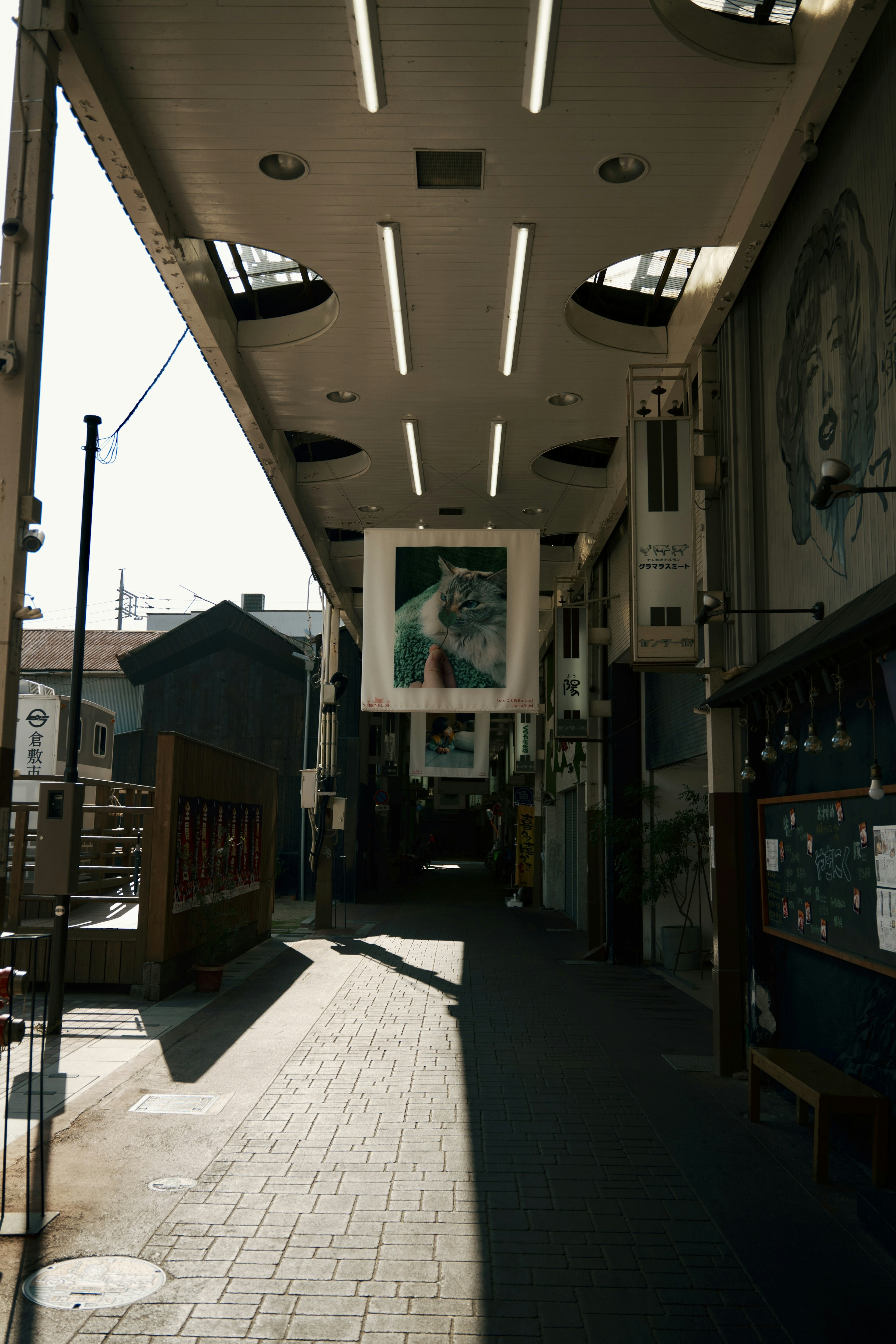 Bright hallway with hanging art pieces in an arcade