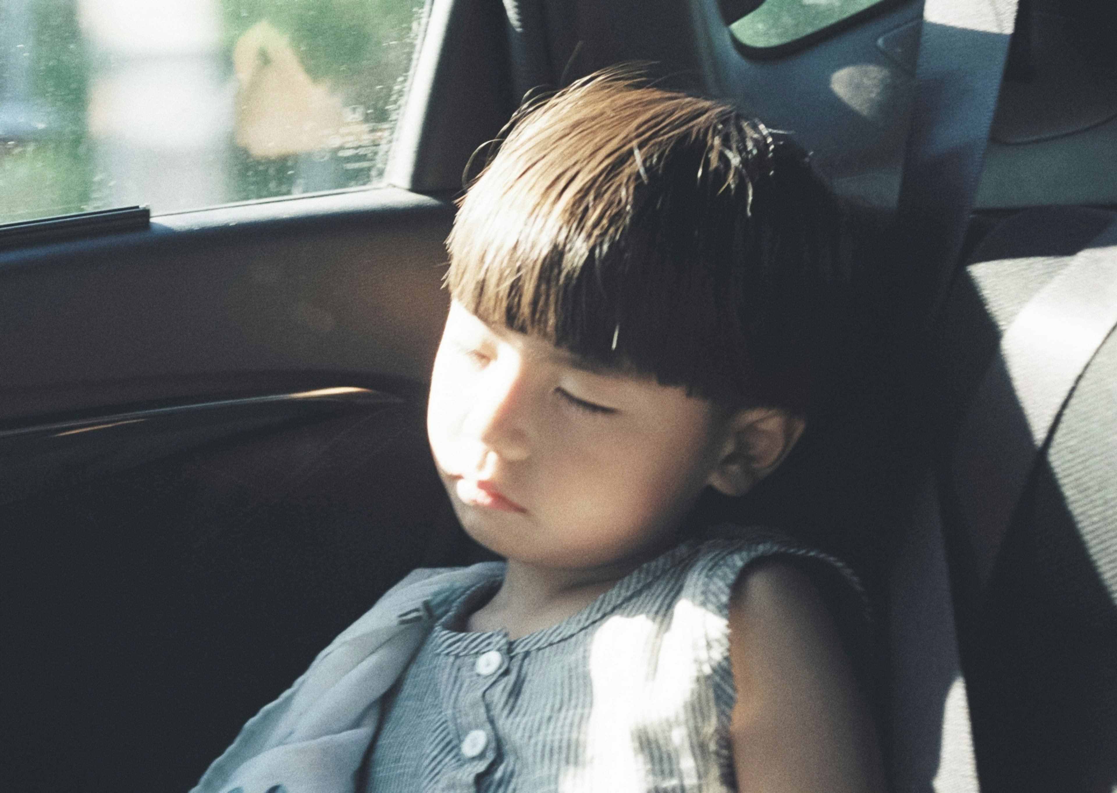 Un bambino che dorme in auto