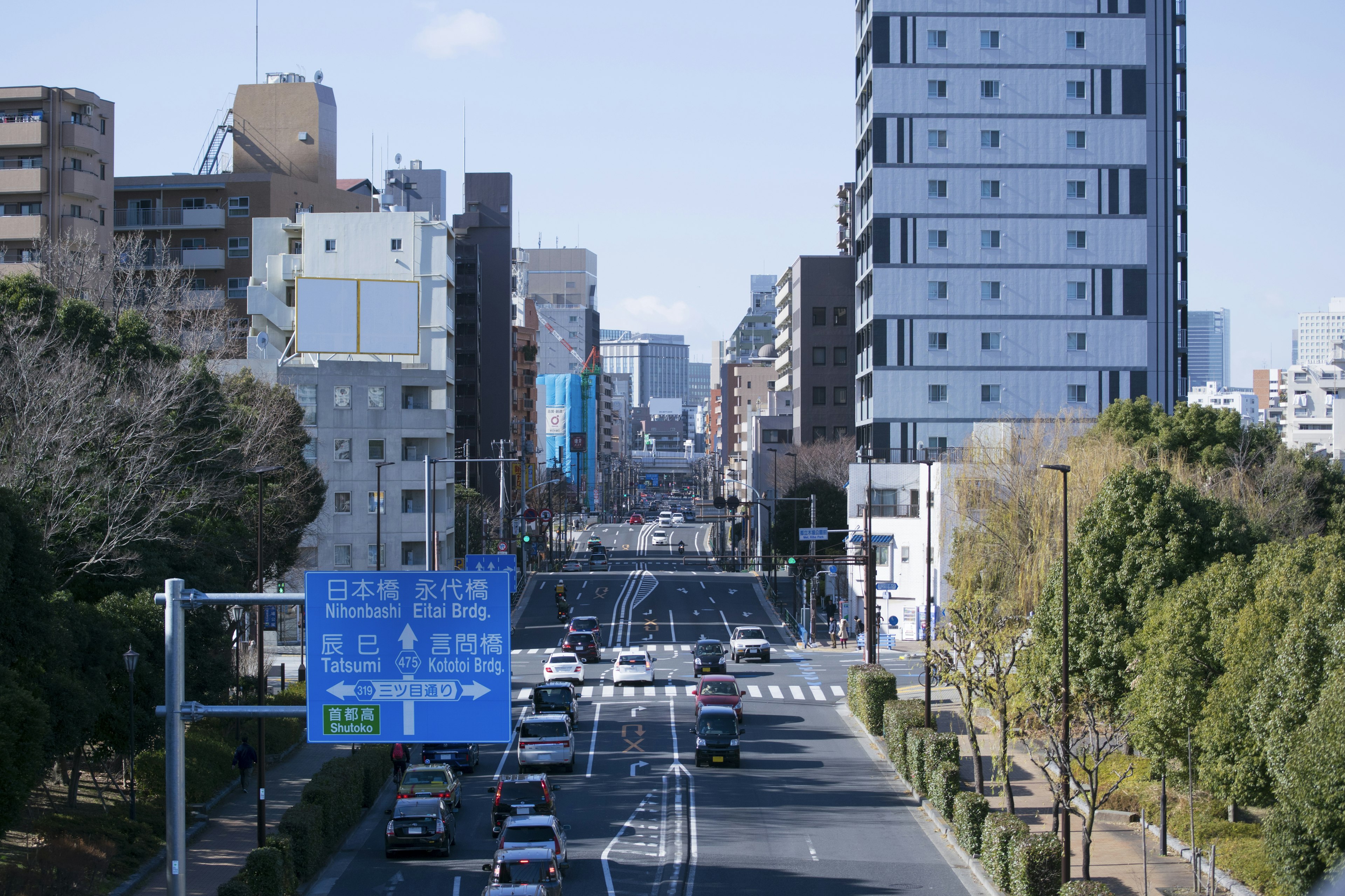 City street with high-rise buildings and traffic signs