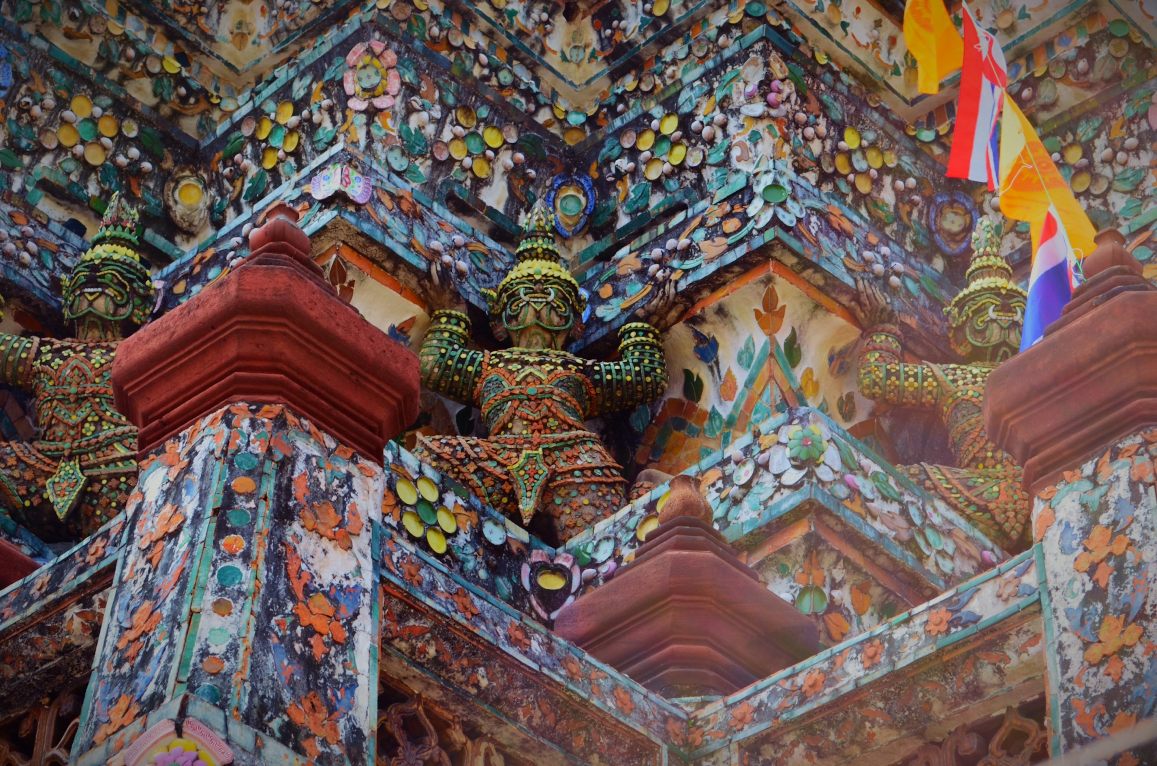 Colorful tiles and sculptures on the exterior wall of a temple with intricate decorations