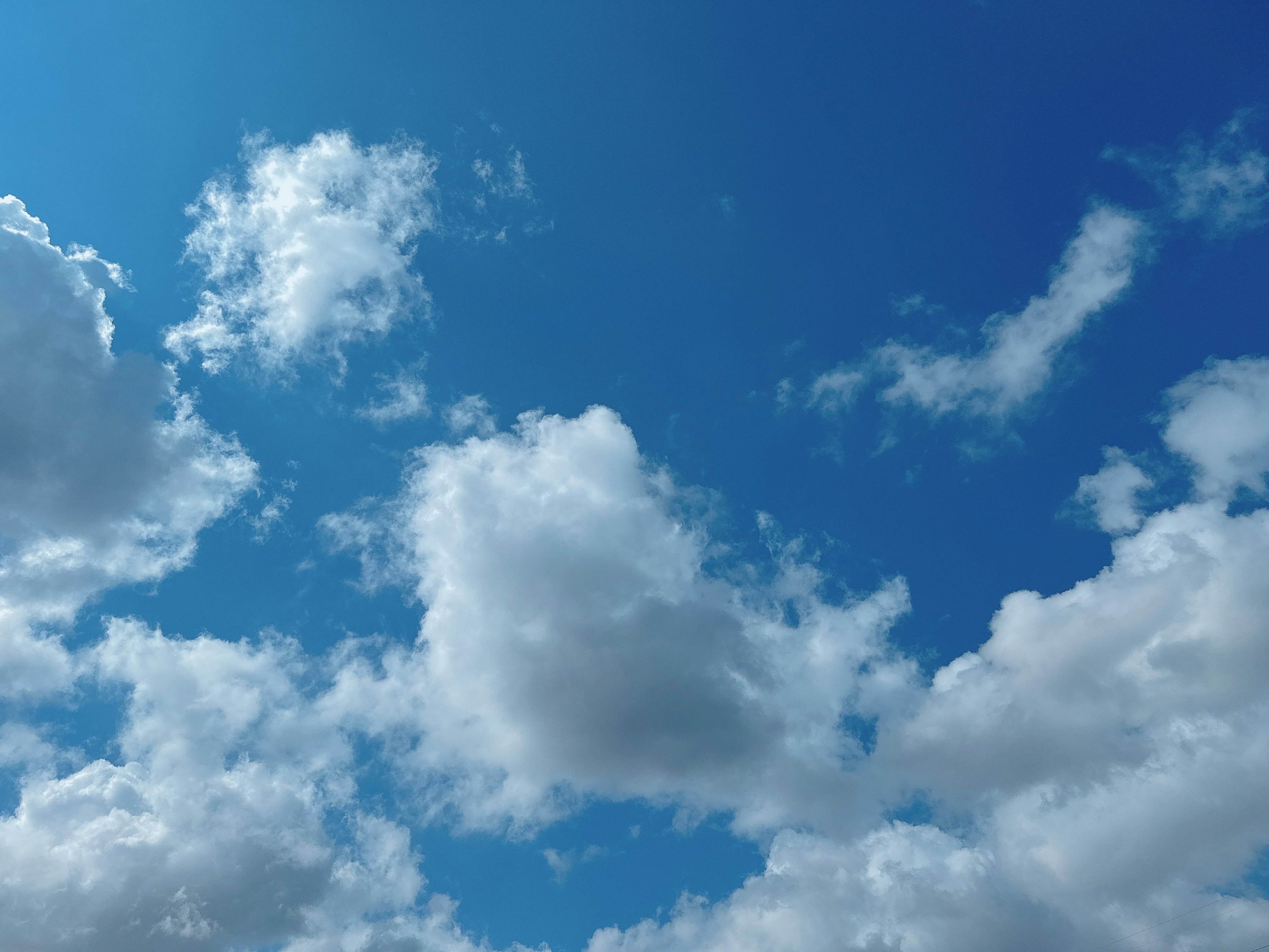 A landscape of white clouds floating in a blue sky