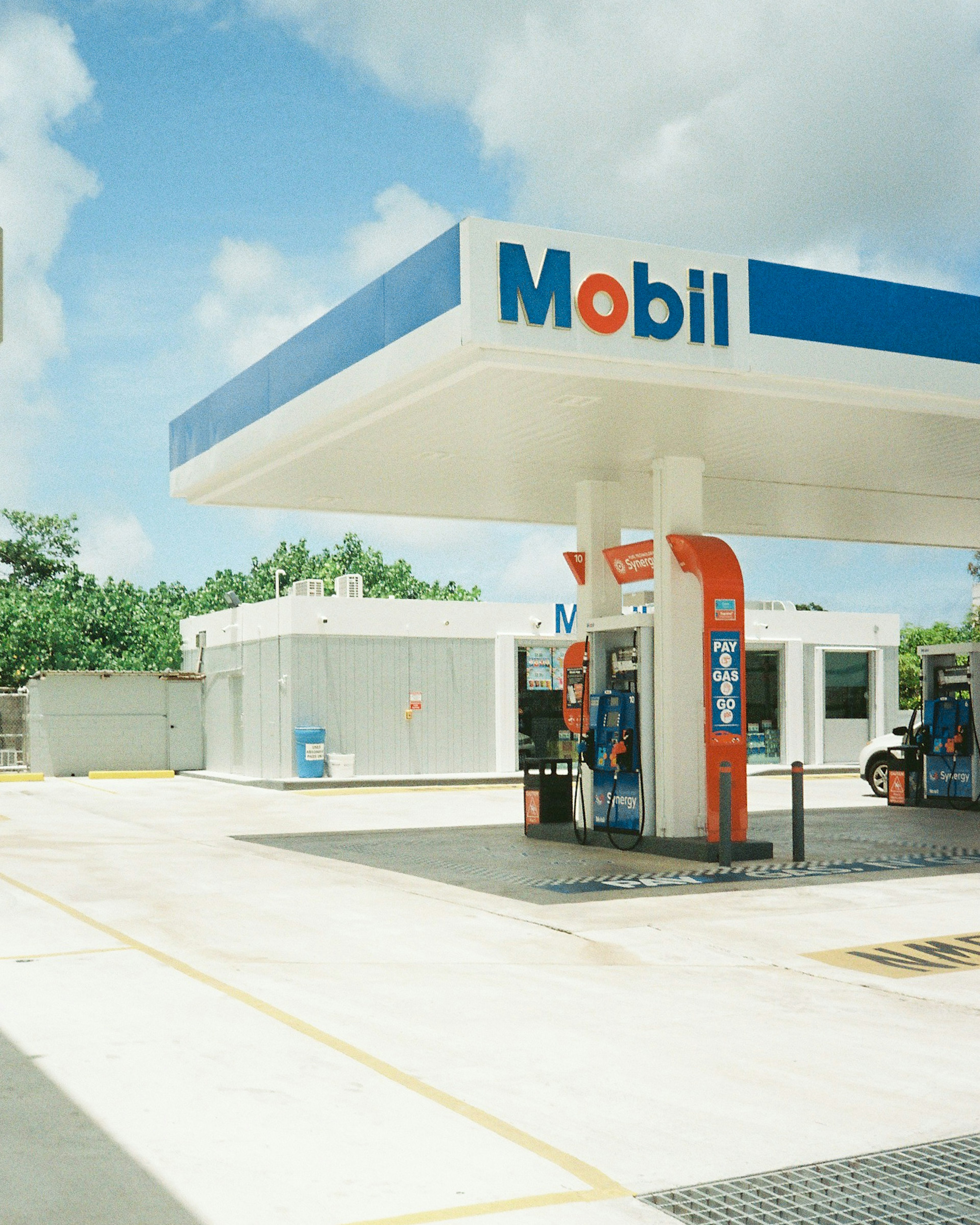 Photo of a Mobil gas station under a blue sky