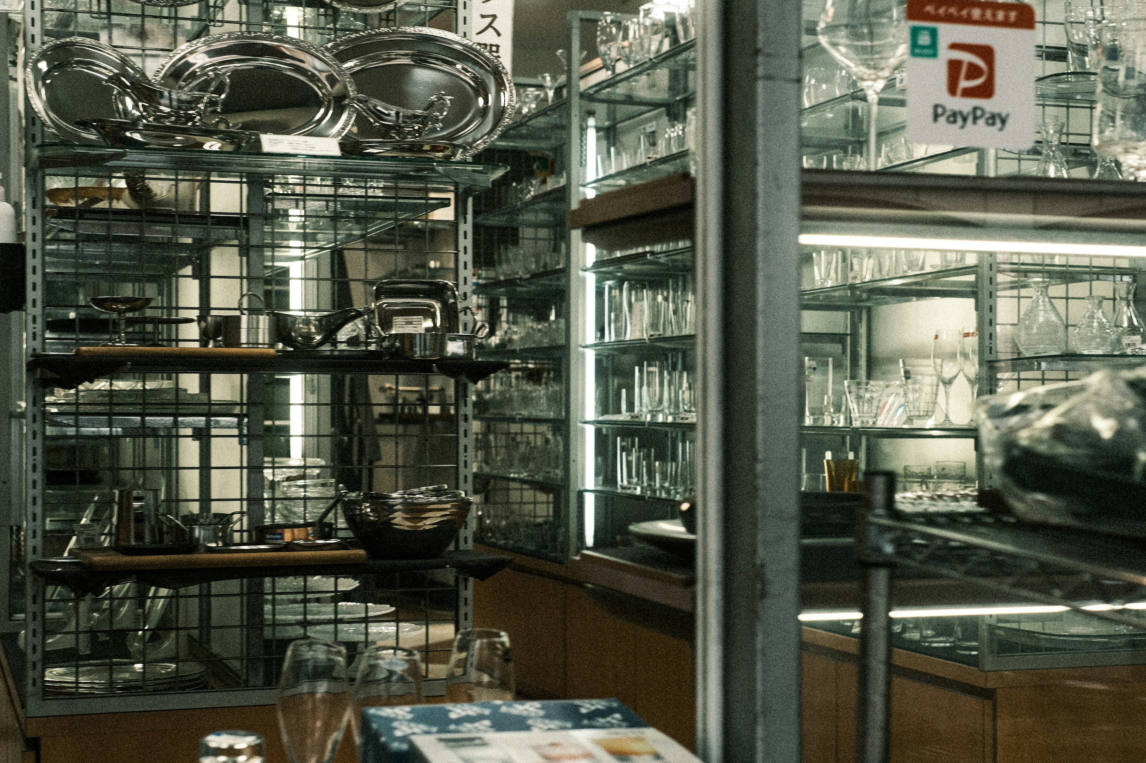 Interior of a store featuring glassware and metal items