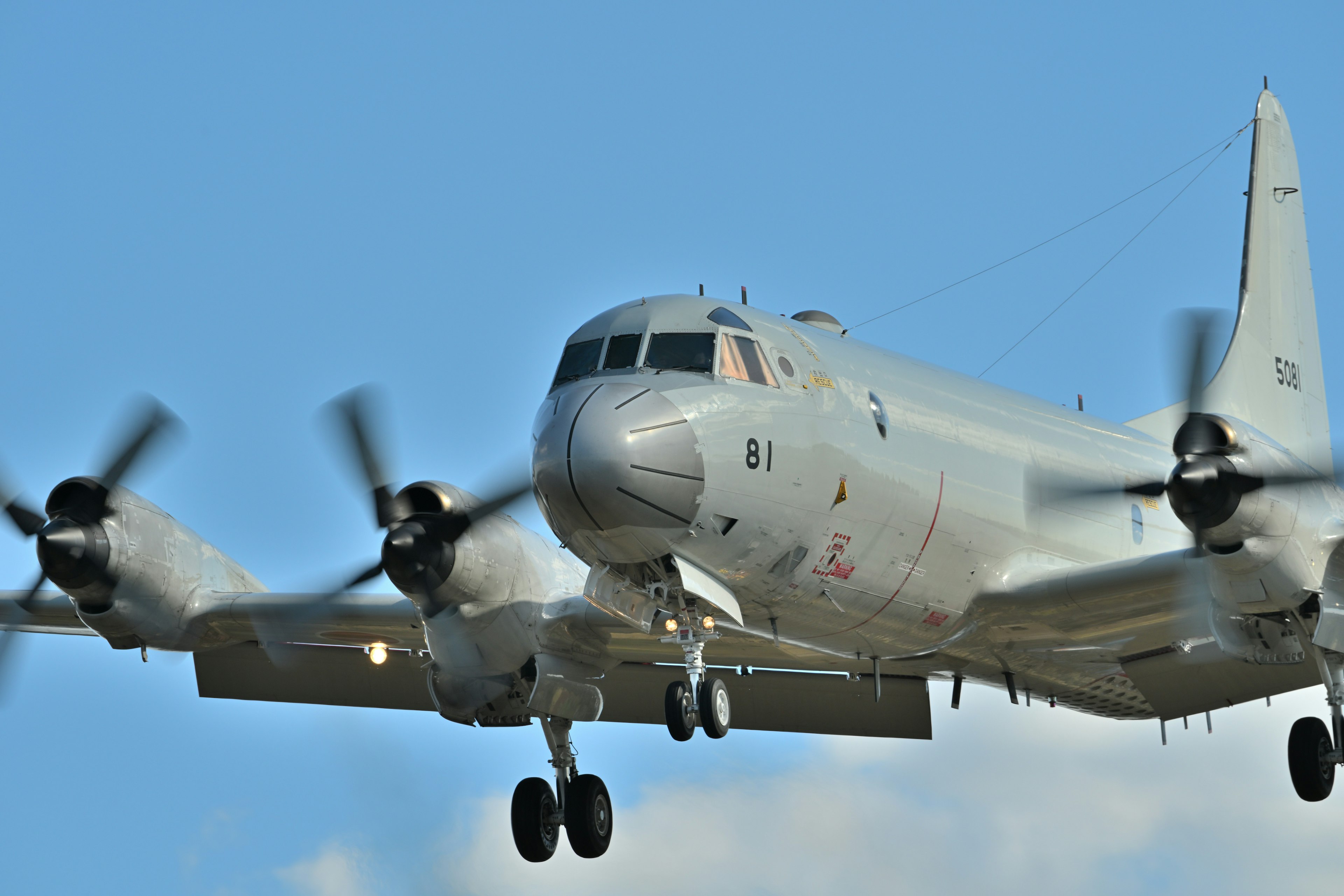 Military aircraft flying with rotating propellers