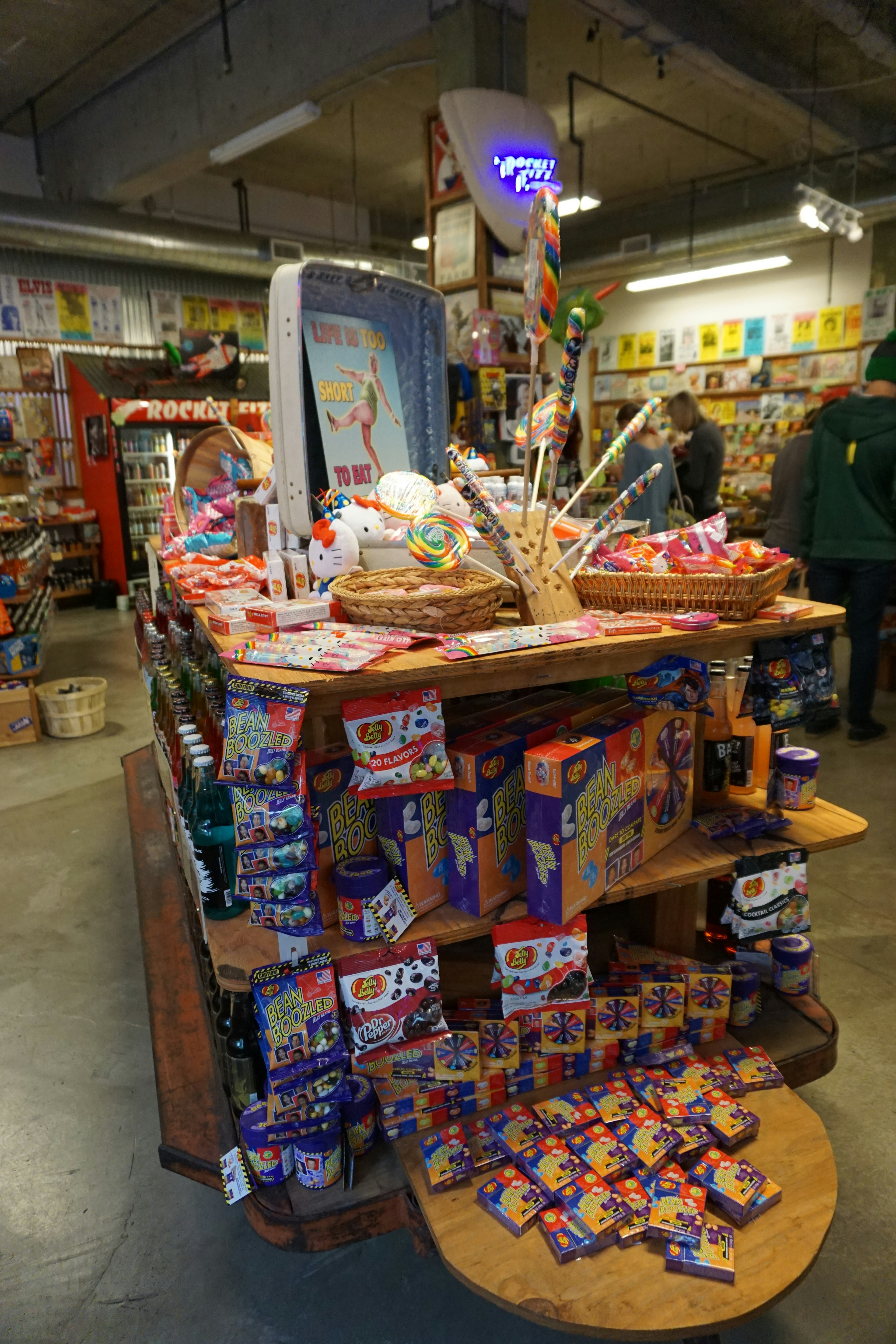 Présentation colorée de bonbons sur une étagère en bois dans un magasin