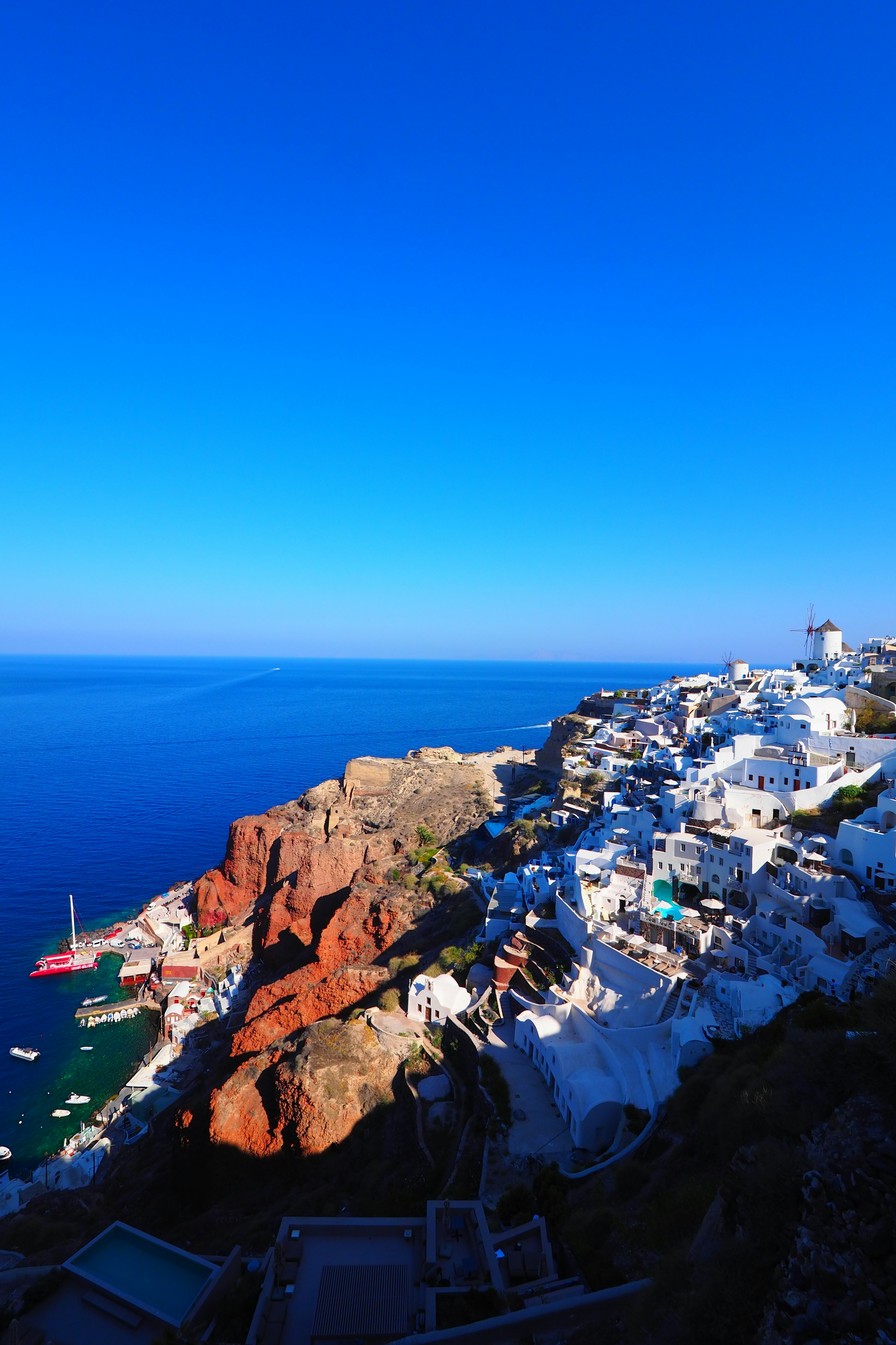 Panoramic view of Santorini with white buildings and blue sea