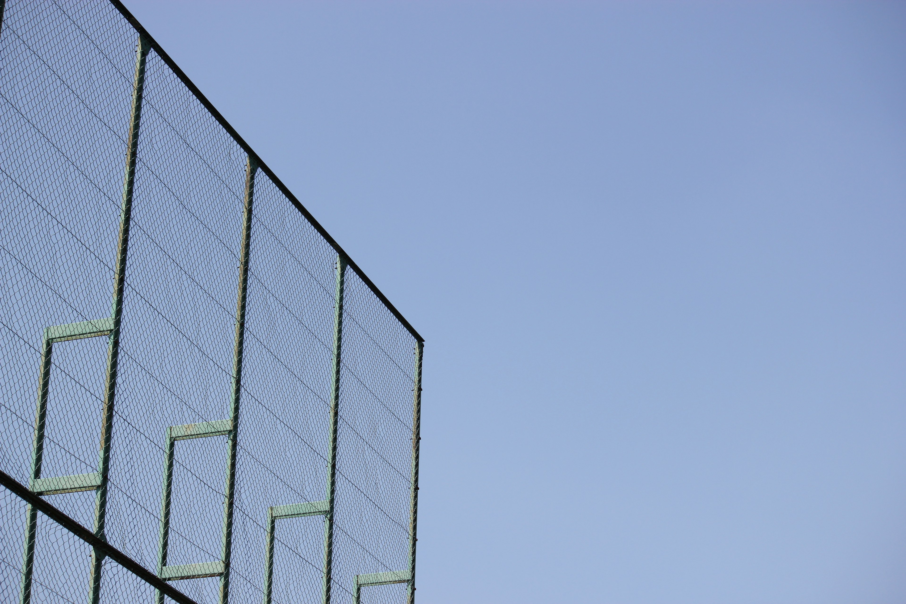 Part of a metal structure extending towards the blue sky