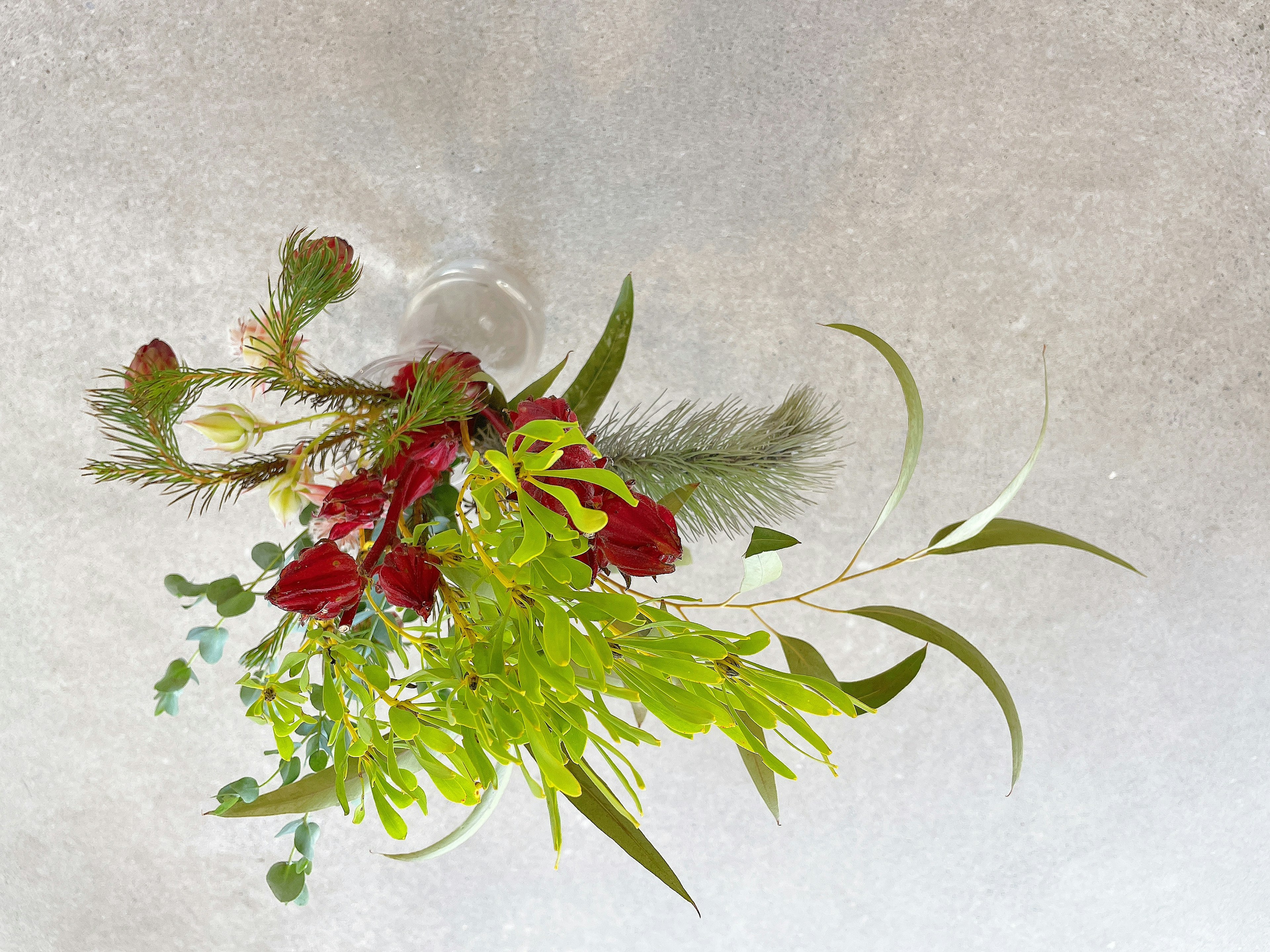 Beautiful arrangement featuring red flowers and green leaves