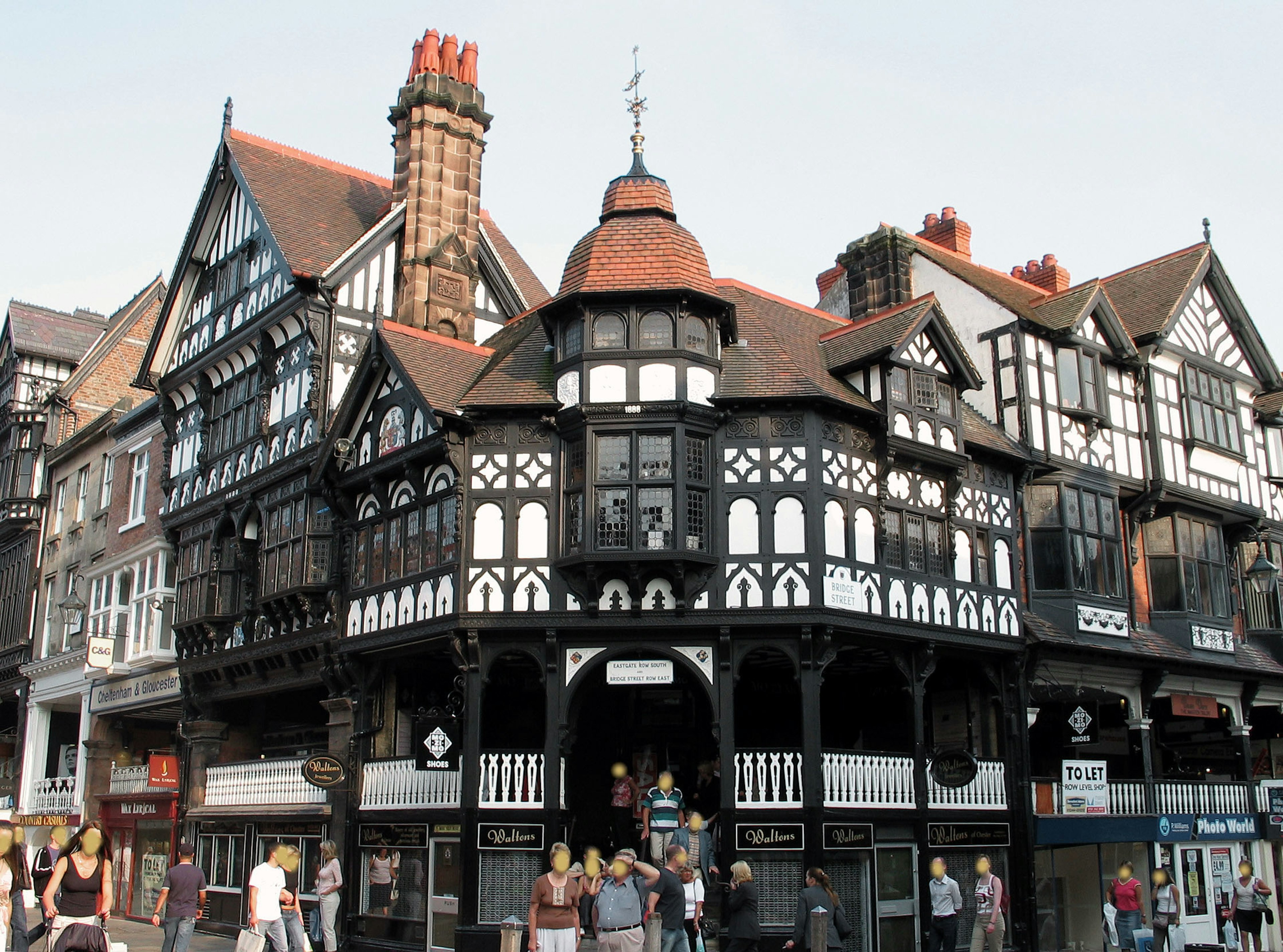 Historic black and white timber-framed building in a bustling street