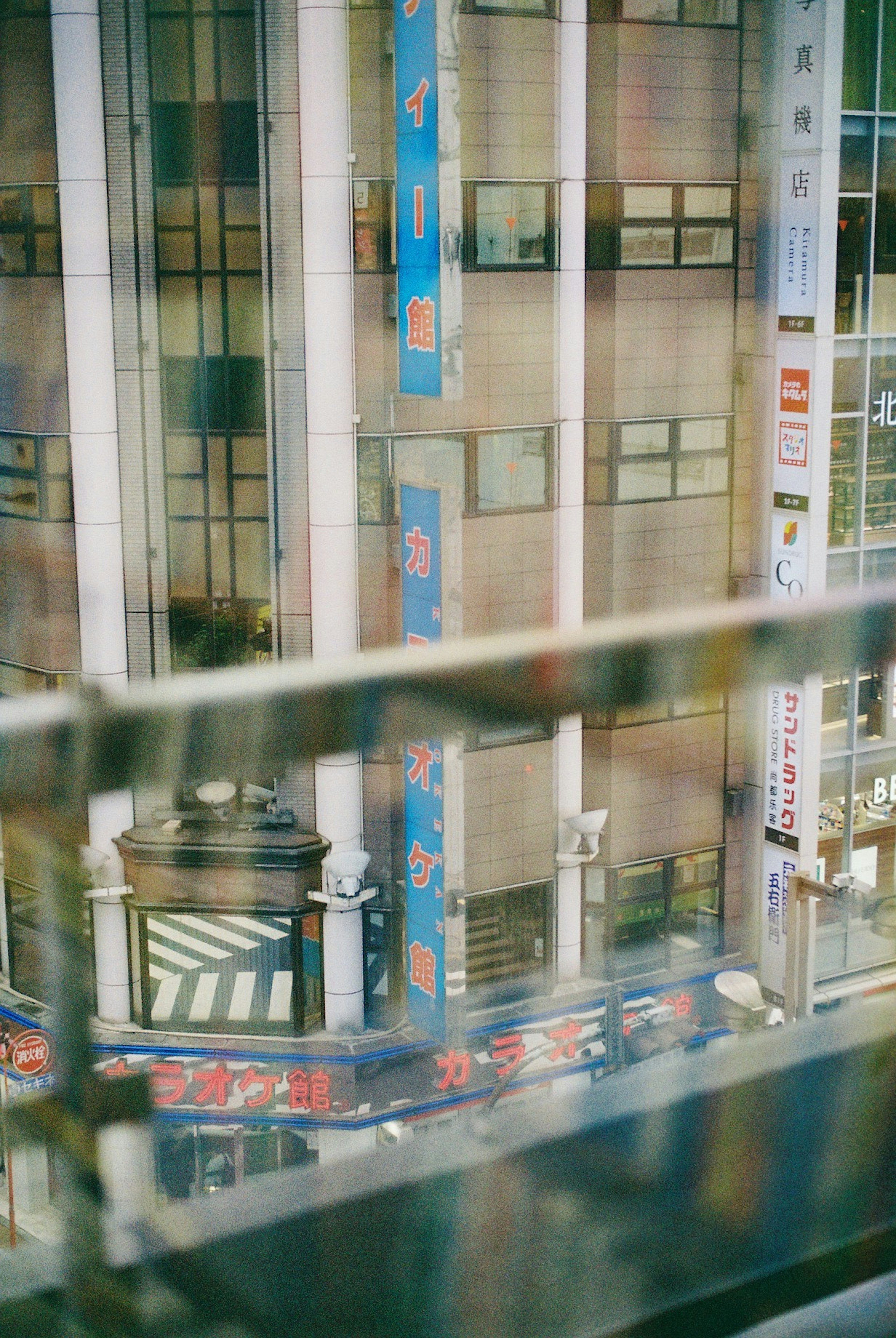 City view through glass with reflections and buildings