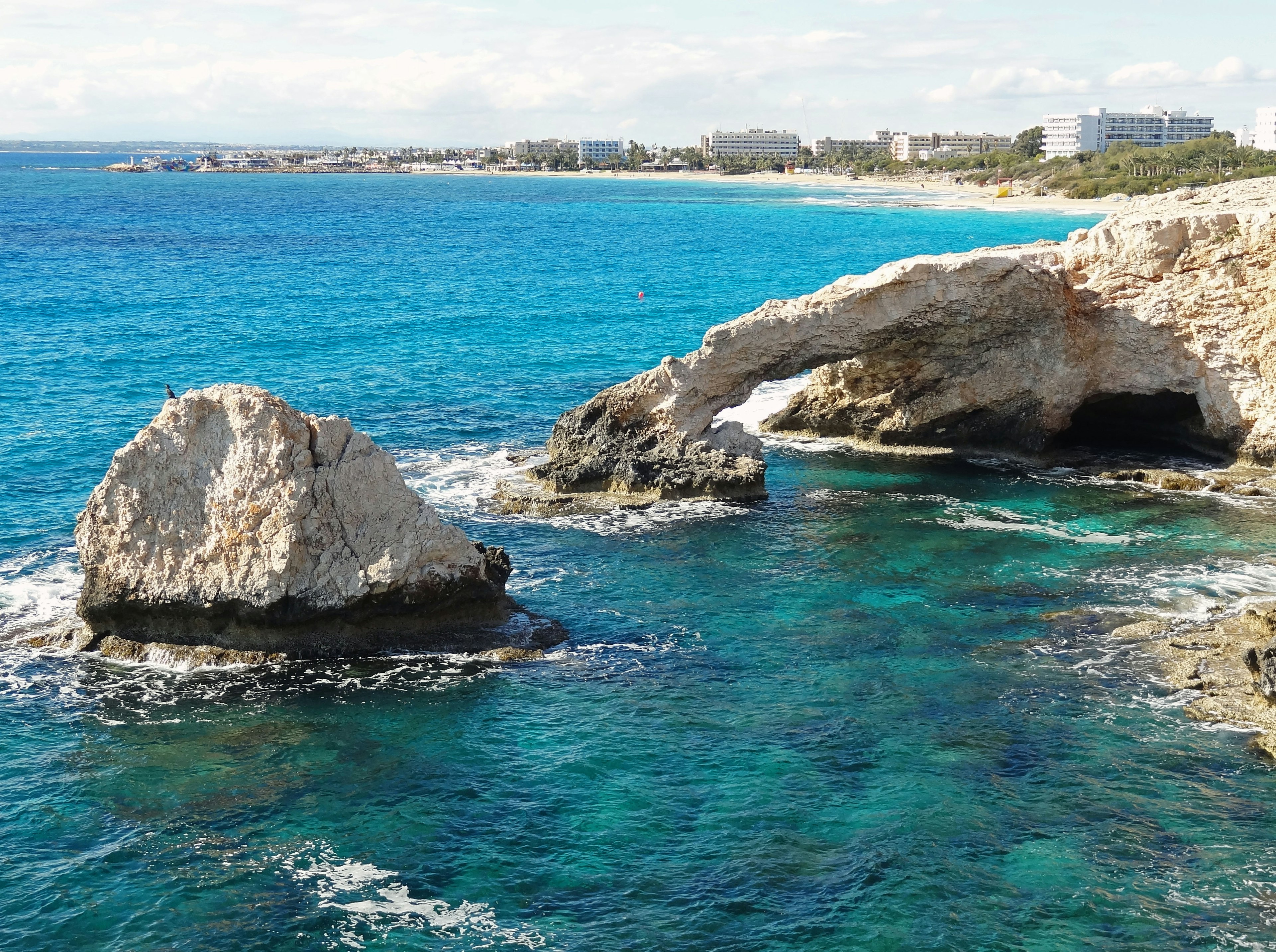 Beautiful coastline with blue sea and rock arch