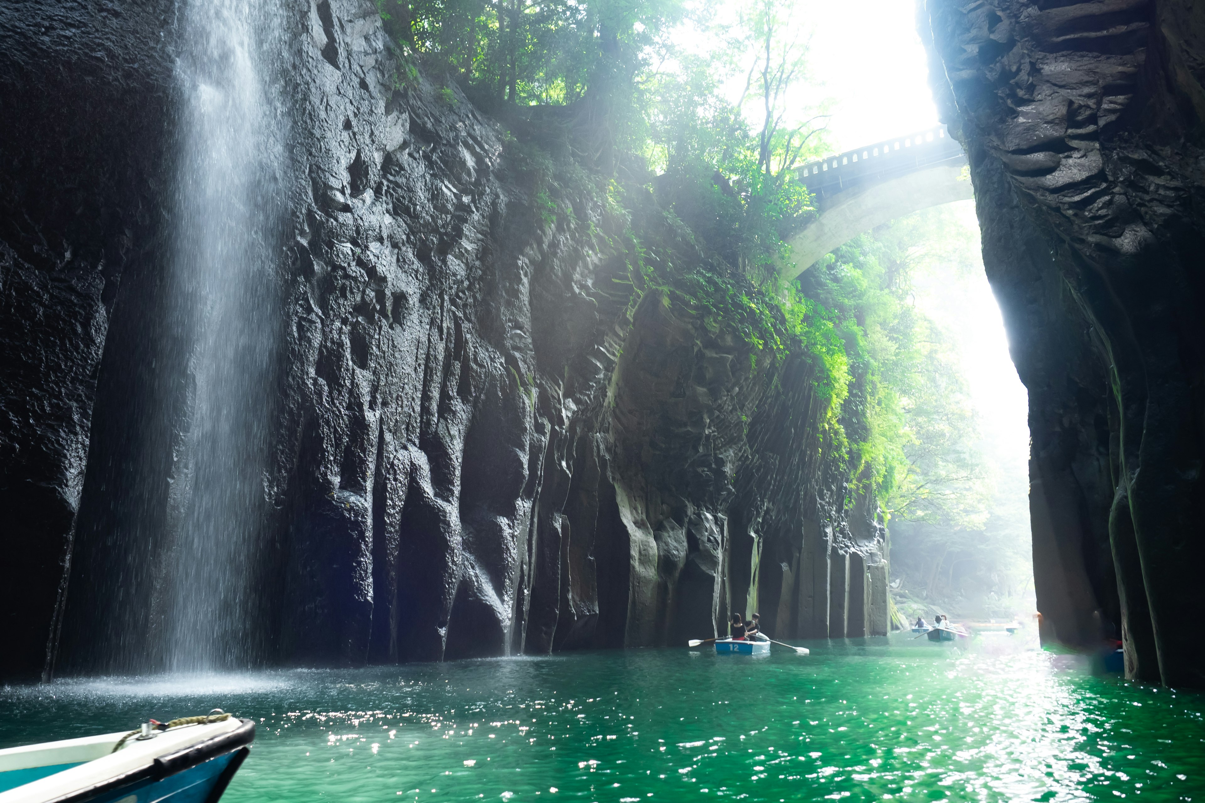 Stunning canyon featuring a waterfall and lush greenery