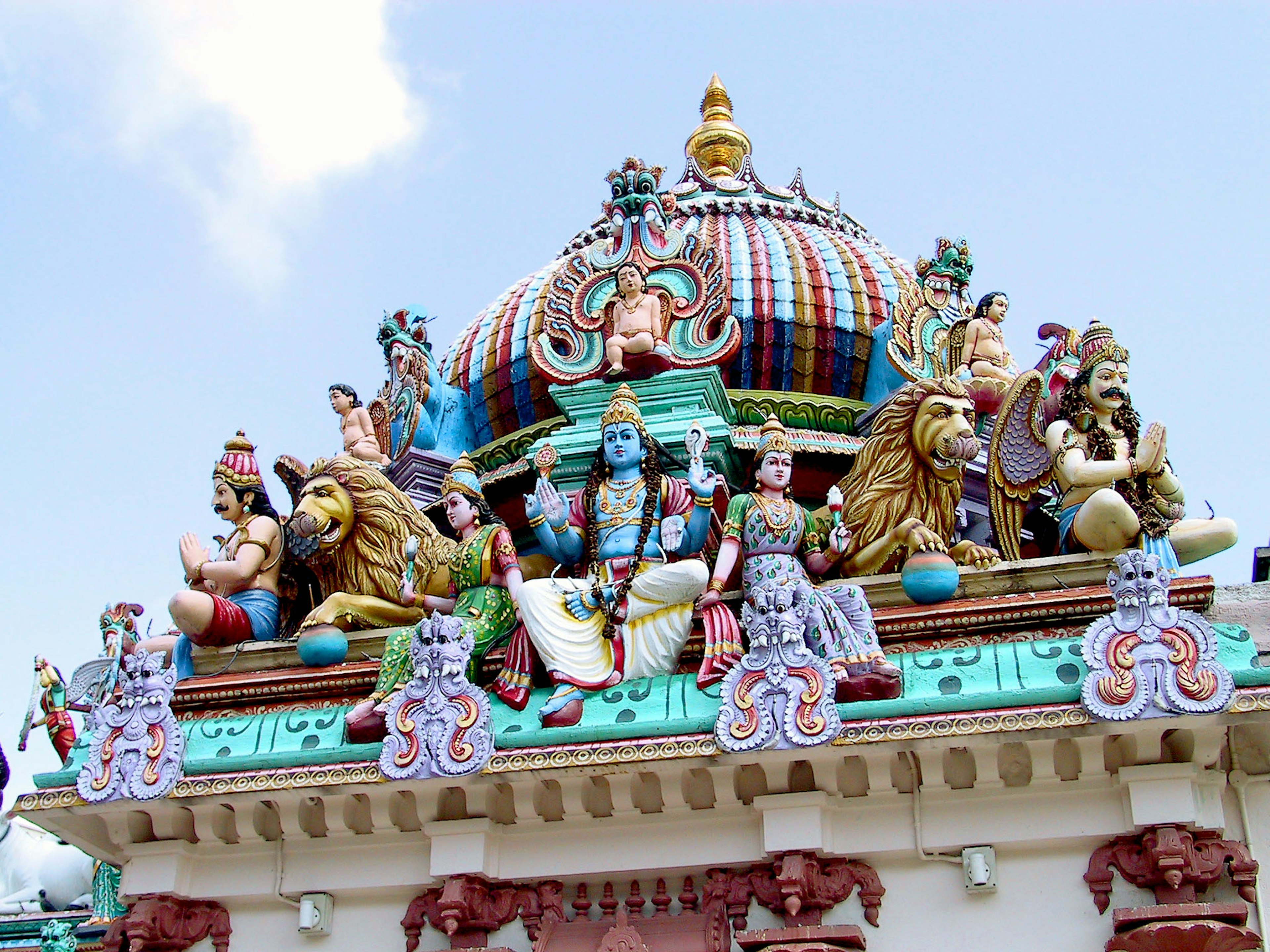 Colorful temple roof adorned with sculptures of deities and mythical creatures