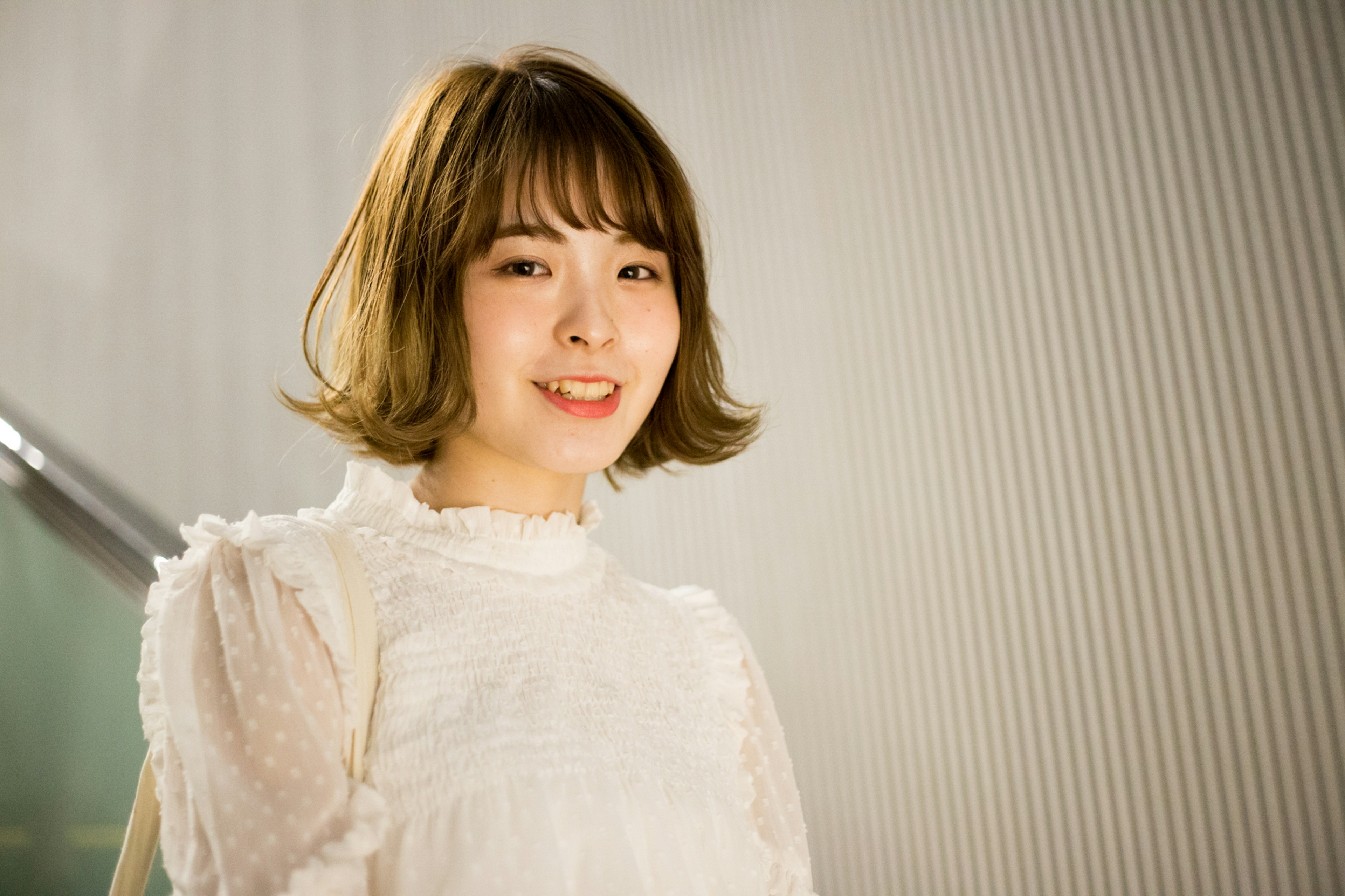 Woman smiling in a white blouse