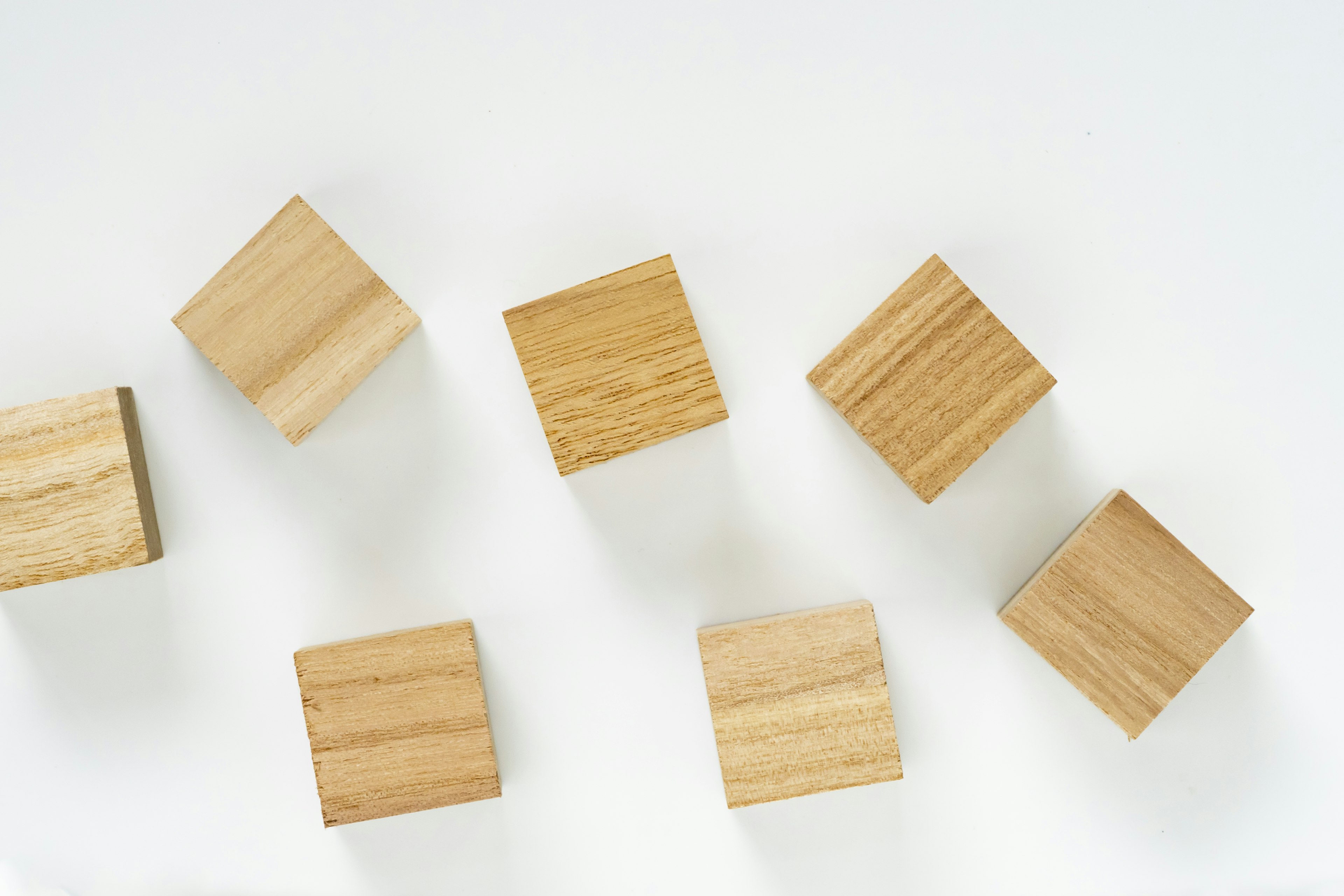 Wooden cubes scattered on a white background