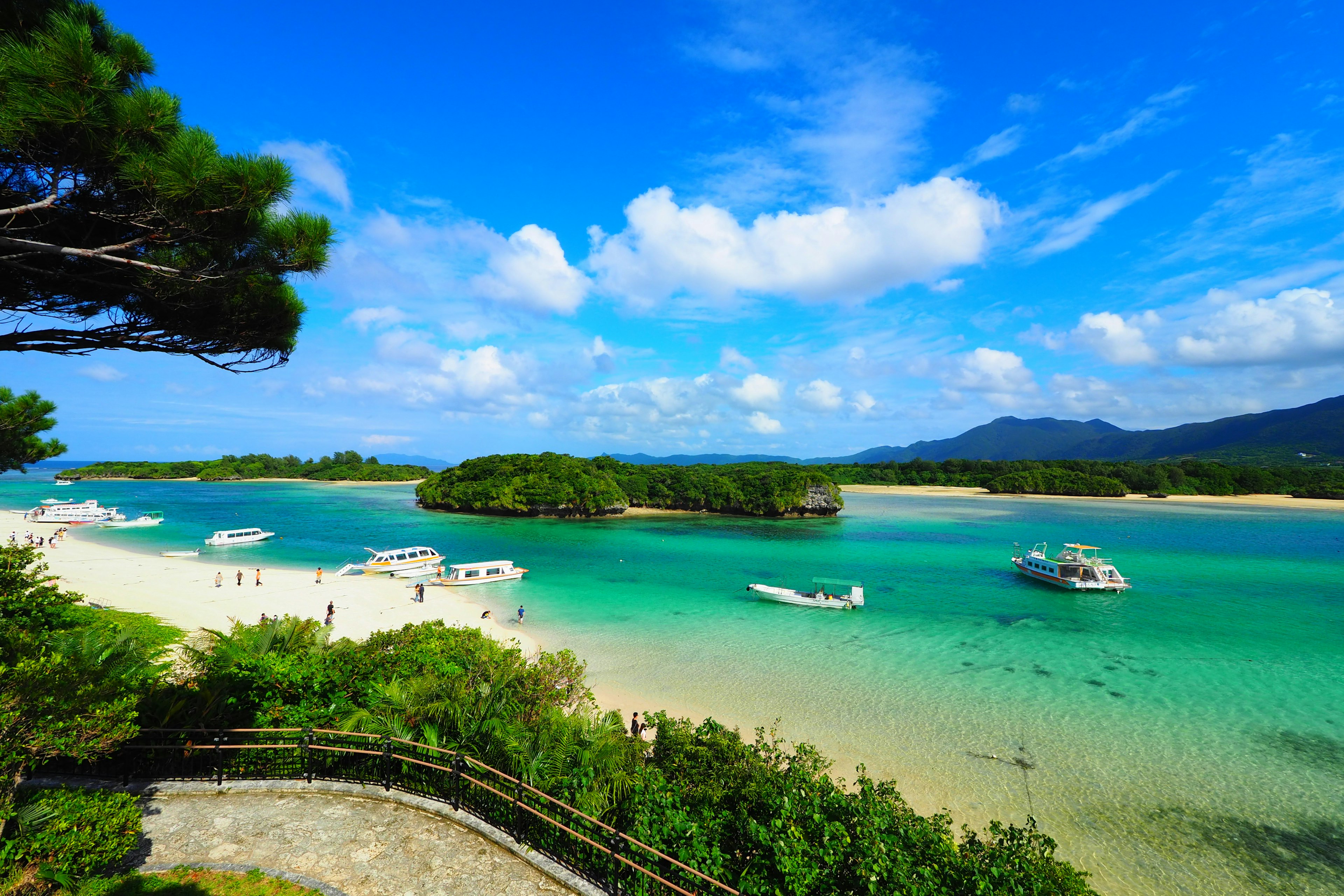 Vue panoramique d'eaux turquoise avec des bateaux et des îles verdoyantes